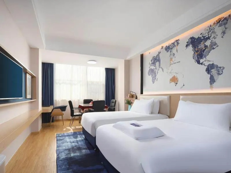 Bed in Kyriad Marvelous Hotel Yiyang Ziyang