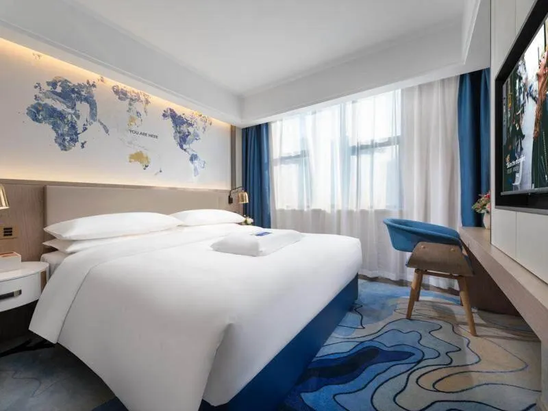 Bed in Kyriad Marvelous Hotel Heyuan Longchuan
