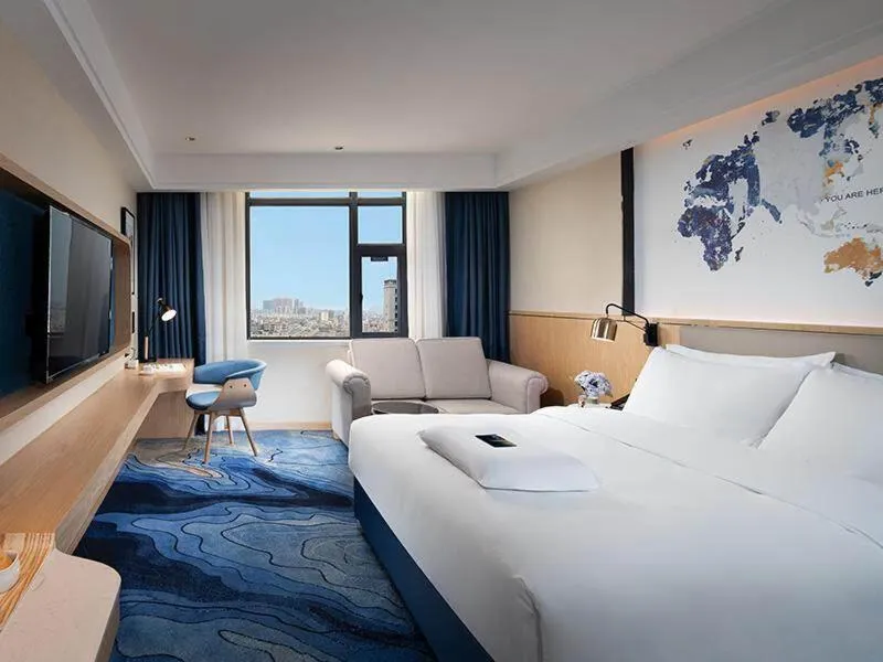 Bed in Kyriad Marvelous Hotel Maoming Dianbai Wanda Plaza