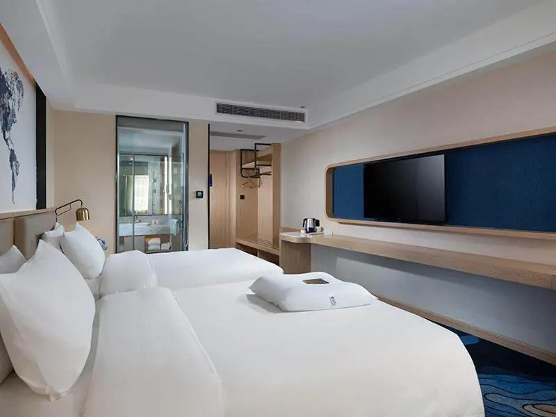 Bed in Kyriad Marvelous Hotel Maoming Dianbai Wanda Plaza