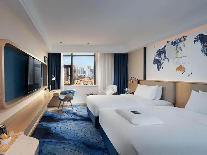 Bed in Kyriad Marvelous Hotel Maoming Dianbai Wanda Plaza