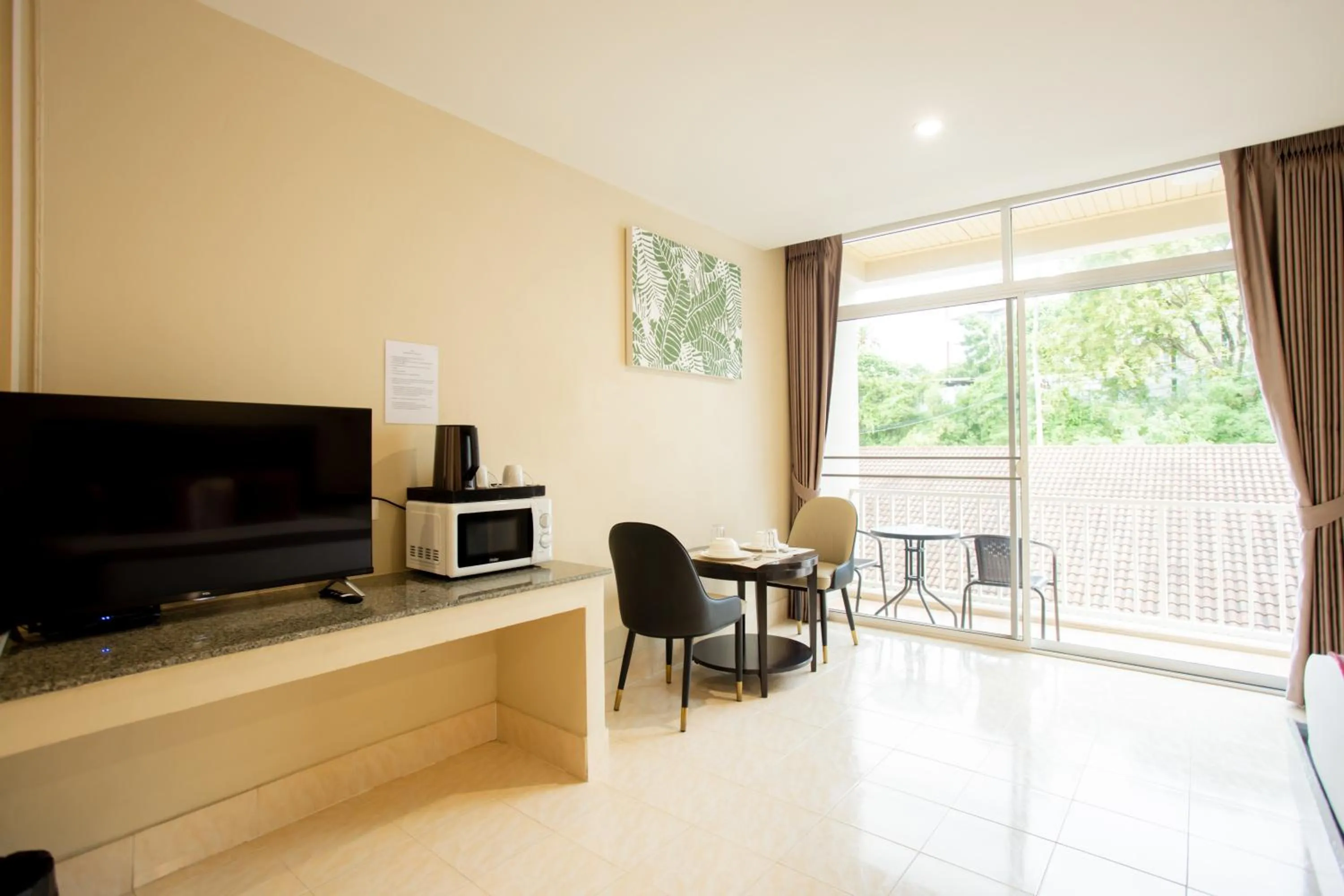 Communal lounge/ TV room in Tri's Miracle Kata Beach Side