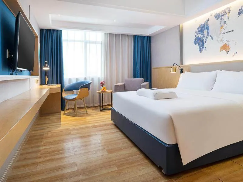 Bed in Kyriad Marvelous Hotel Dongguan Changan Light Rail Station
