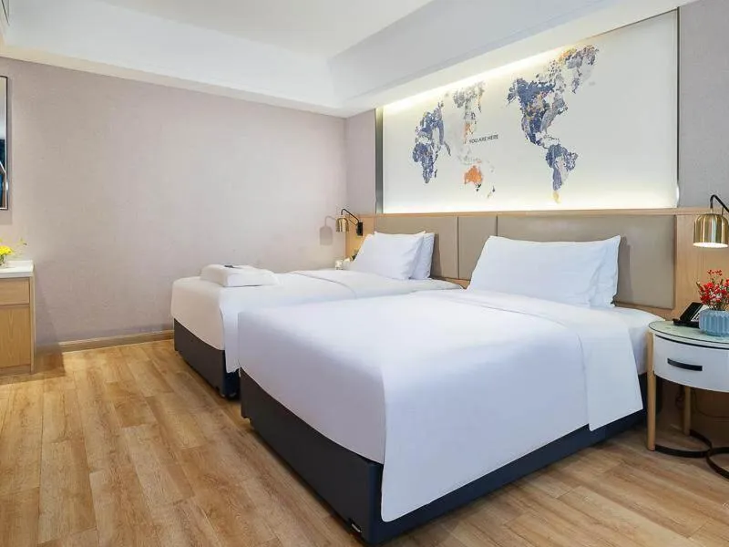 Bed in Kyriad Marvelous Hotel Dongguan Changan Light Rail Station