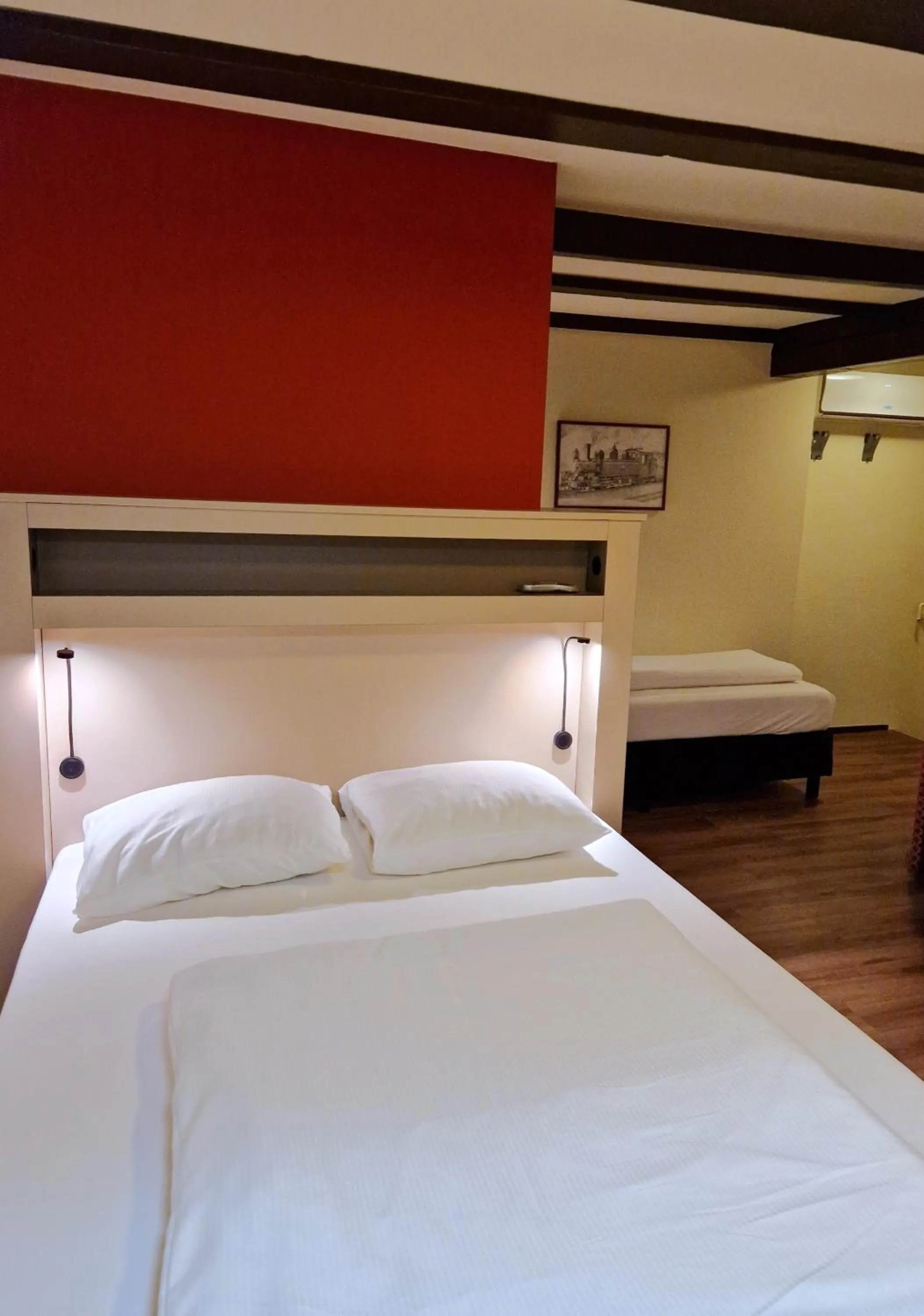 Bed in A-Train Hotel