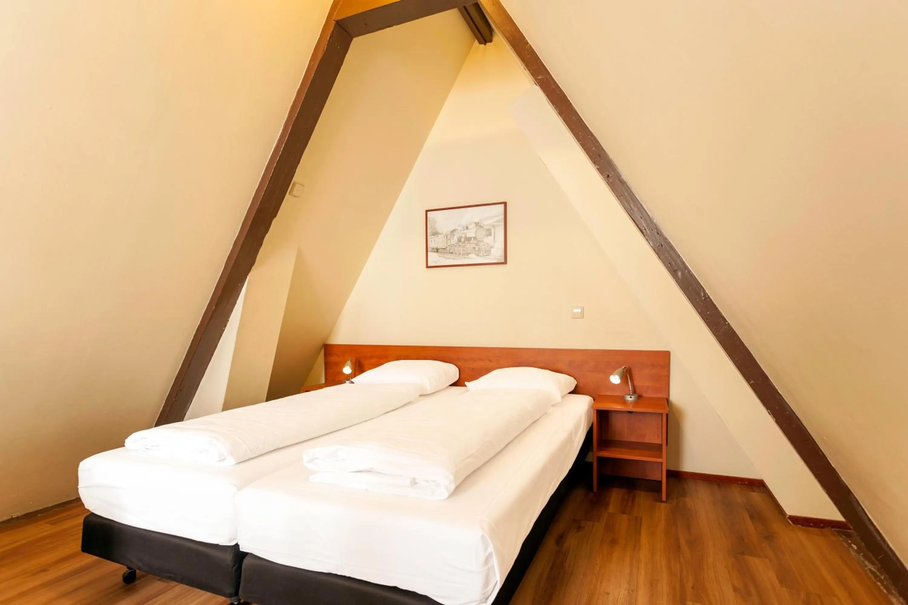 Bed in A-Train Hotel