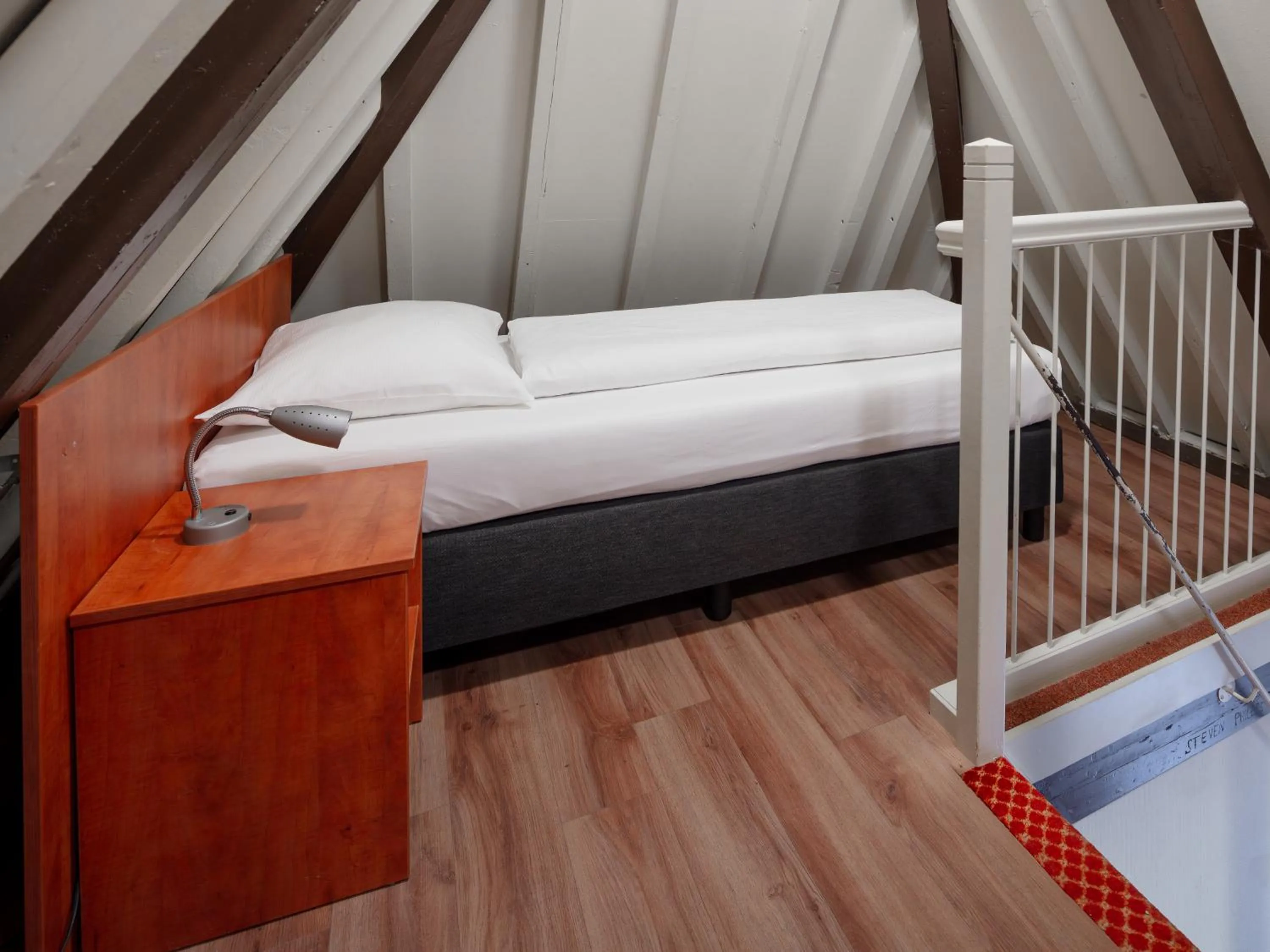 Bed in A-Train Hotel