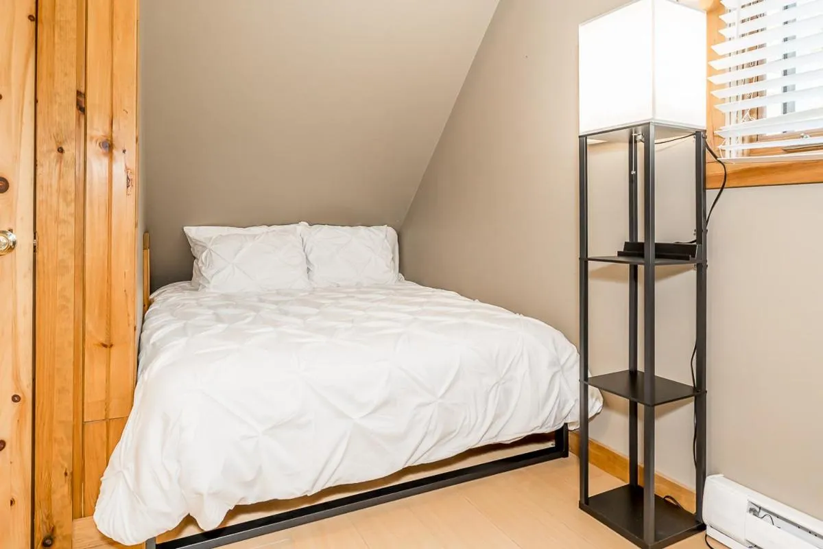 Bed in Muskoka Lakeshore Cottage Bliss