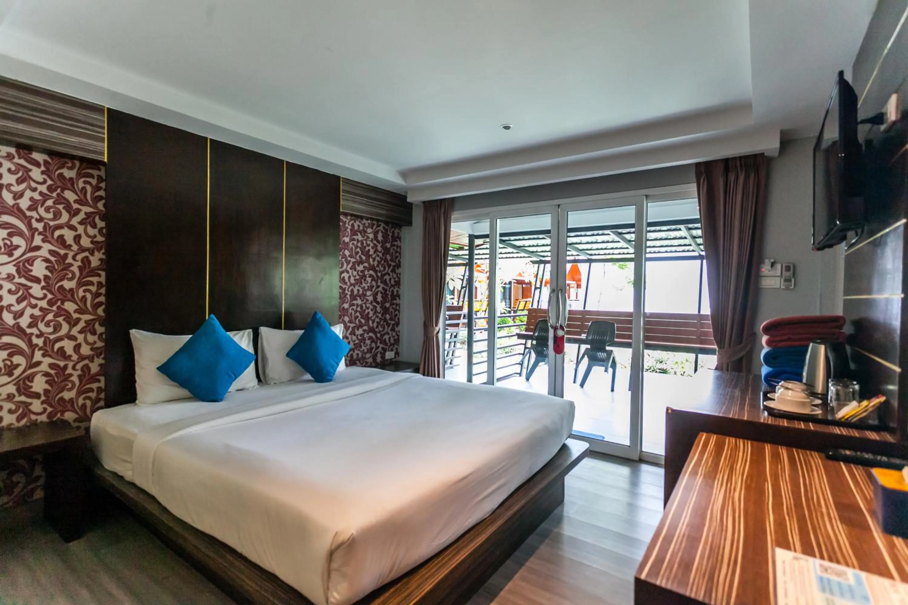 Communal lounge/ TV room, Bed in Coco Bella Hotel