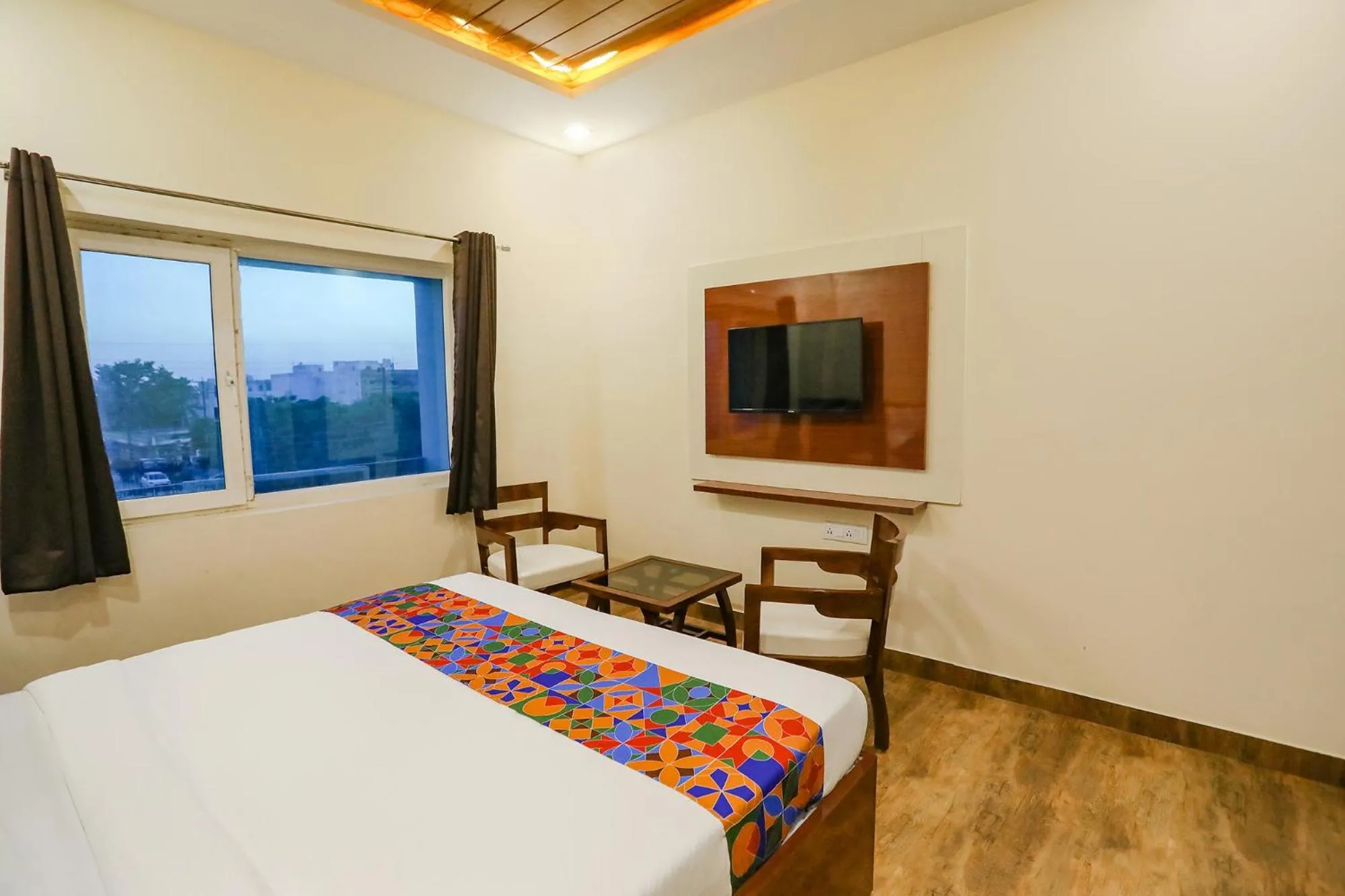 Communal lounge/ TV room, Bed in FabExpress Trijal Inn