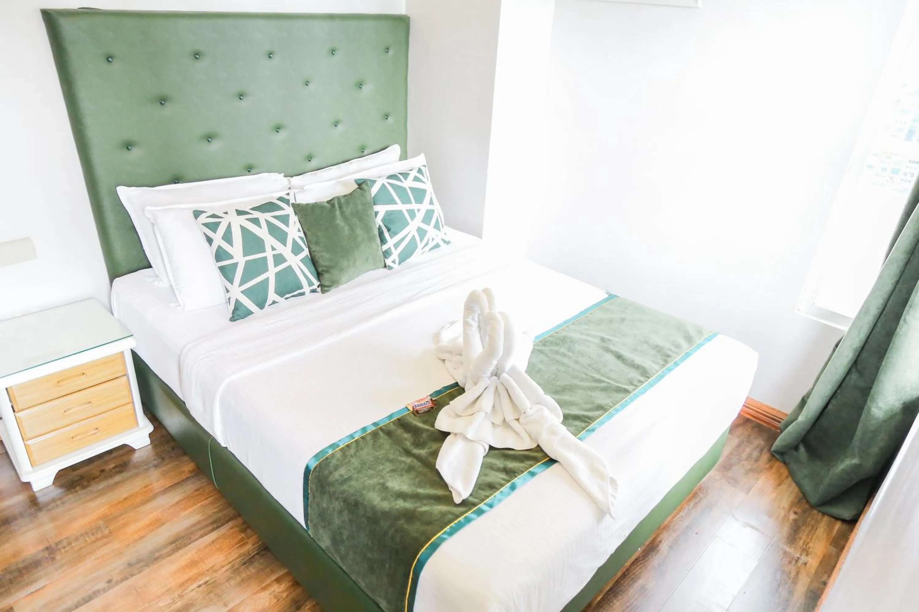 Bed in Pacific Bay Grand Suites