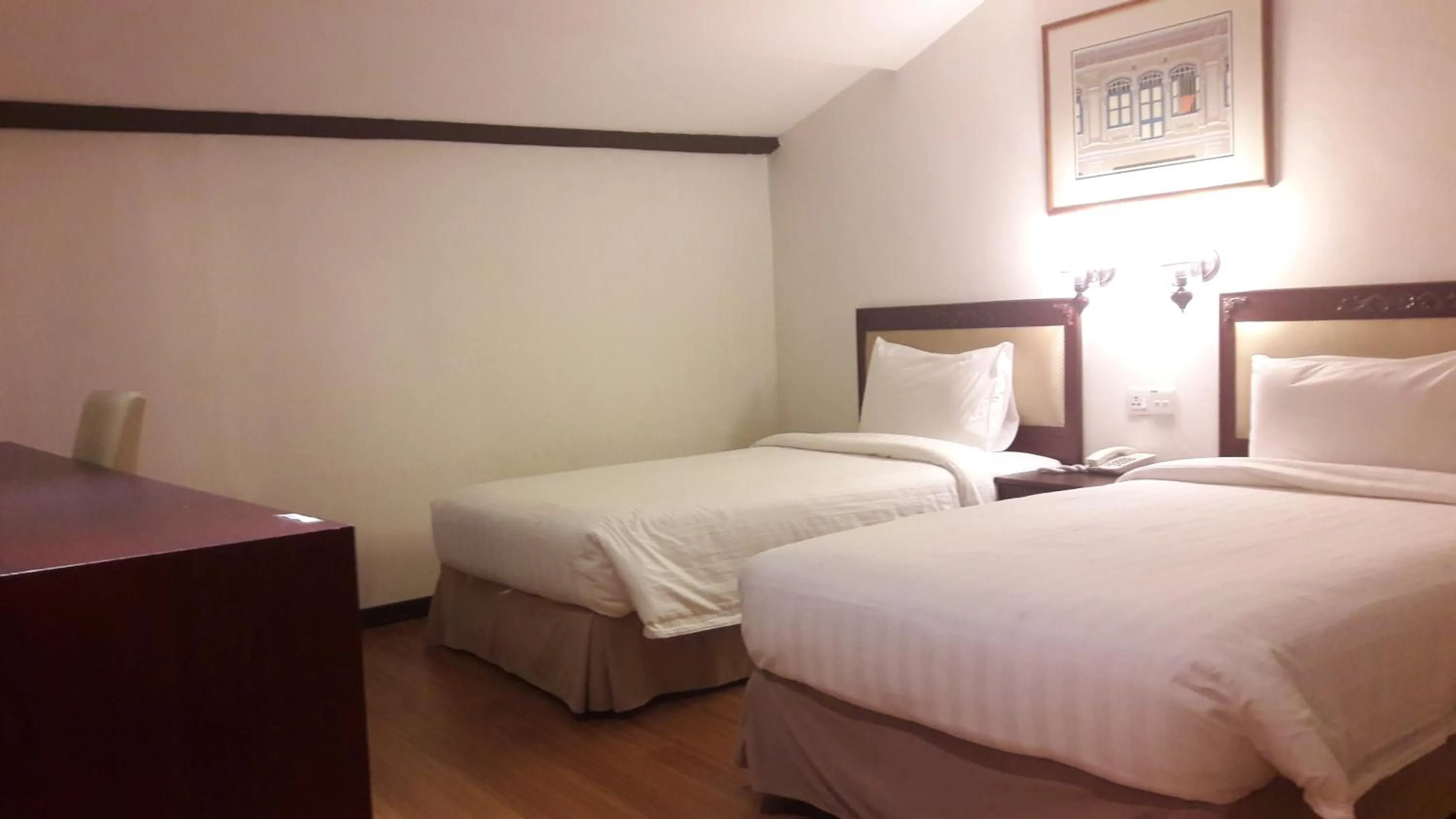 Bed in Cheng Ho Hotel