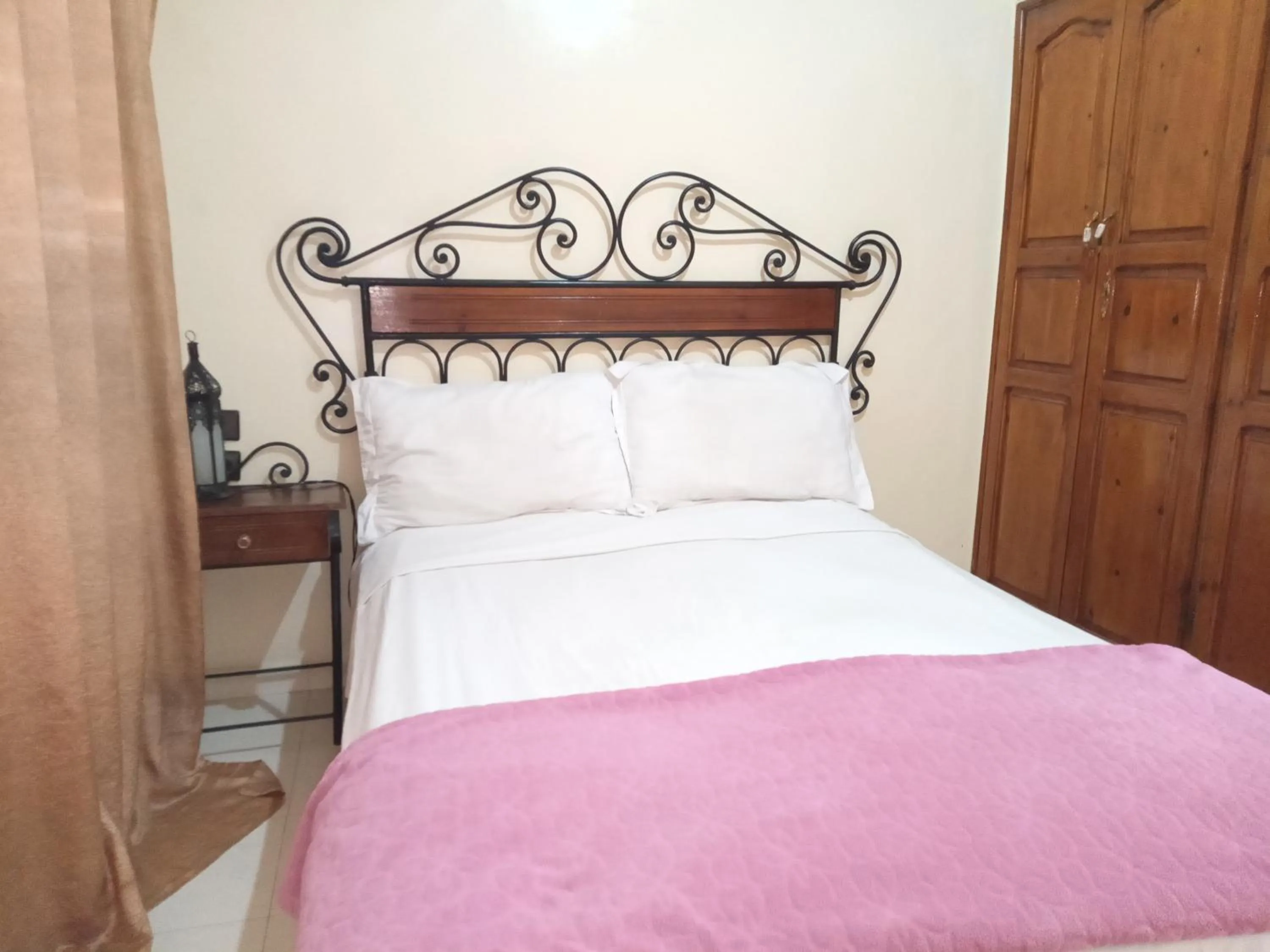 Bed in APPART AIGLE HOTEL