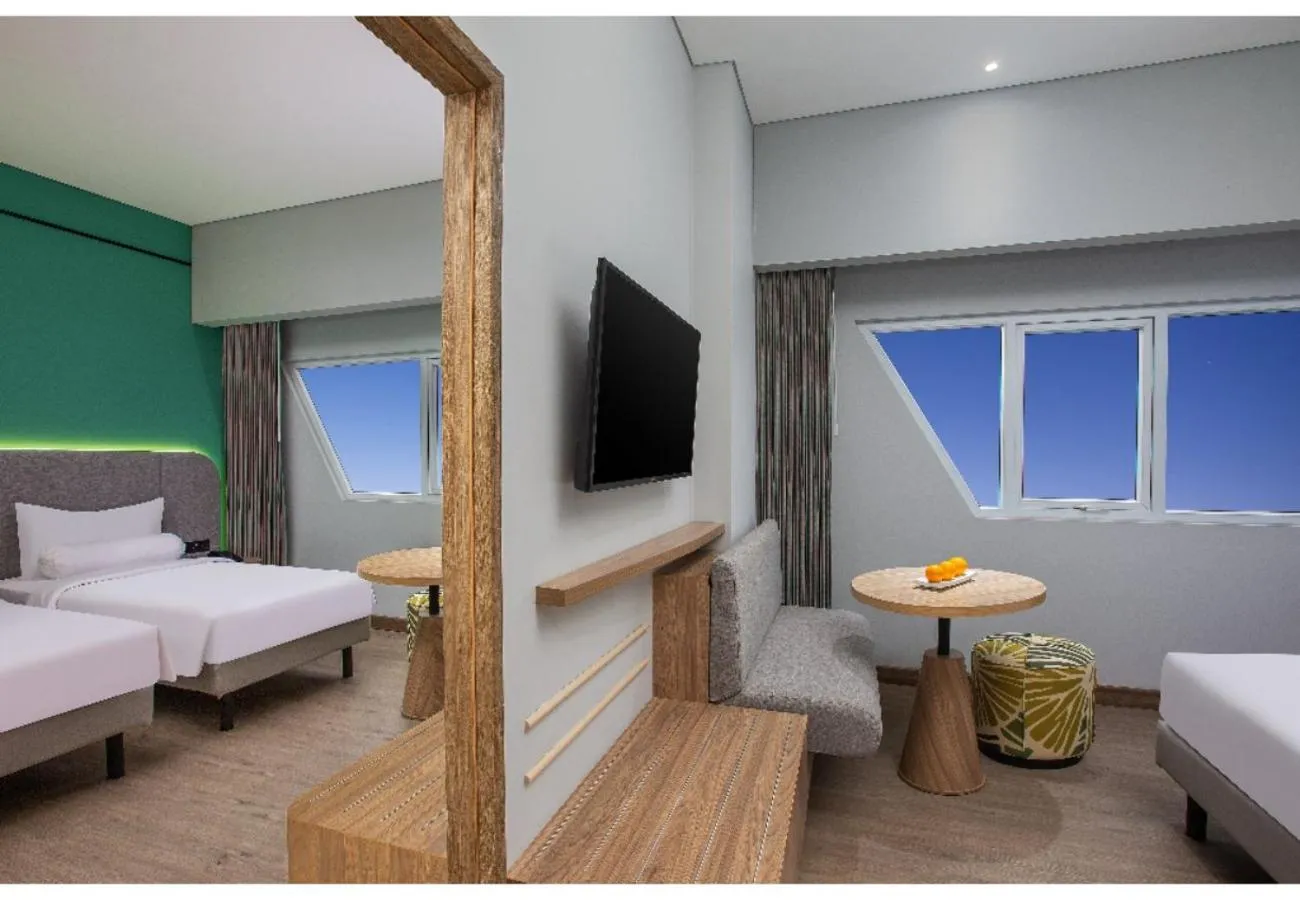 Seating area, Bed in Harper Banjarmasin by ASTON