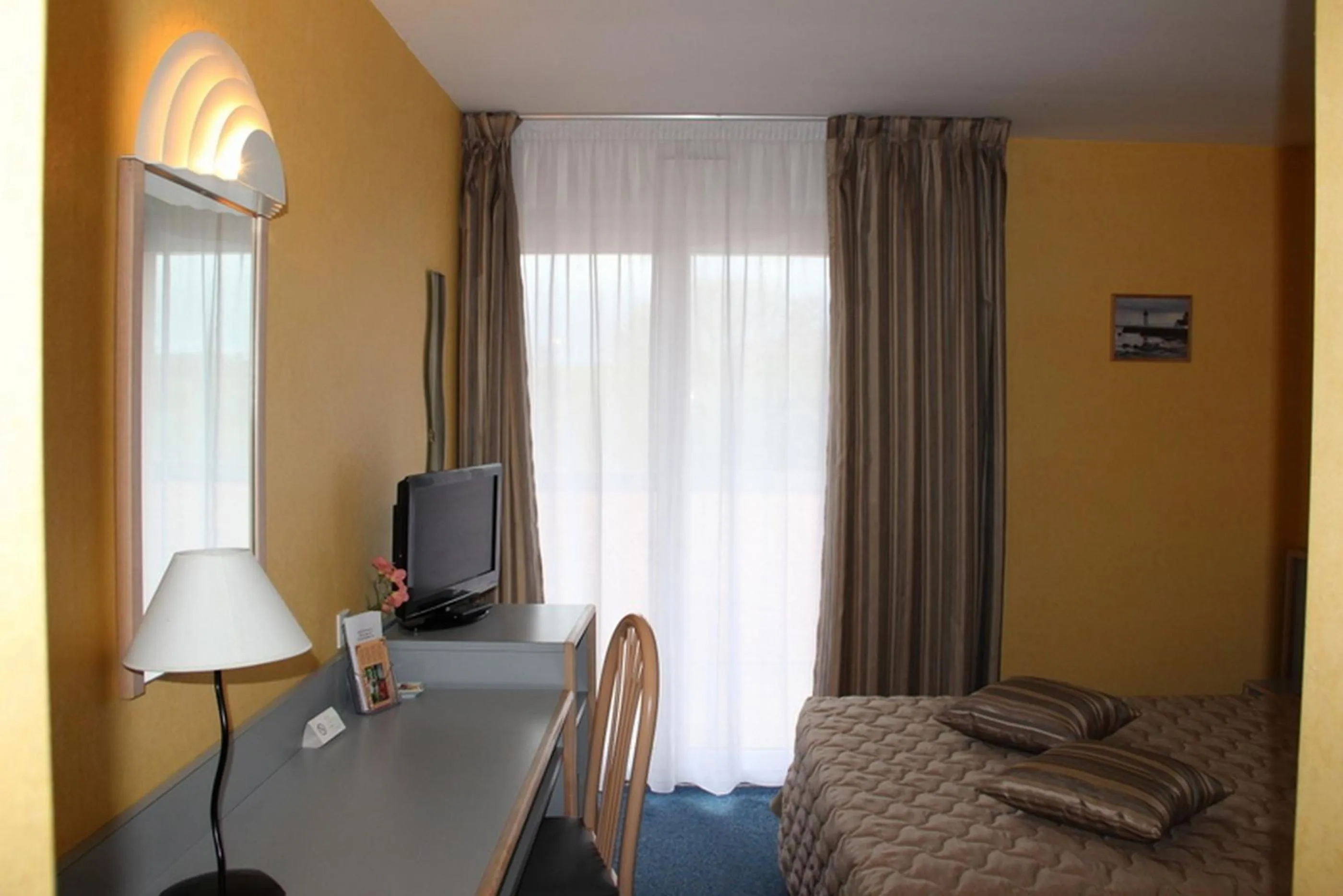 Bed in Au Relais de l'Oust