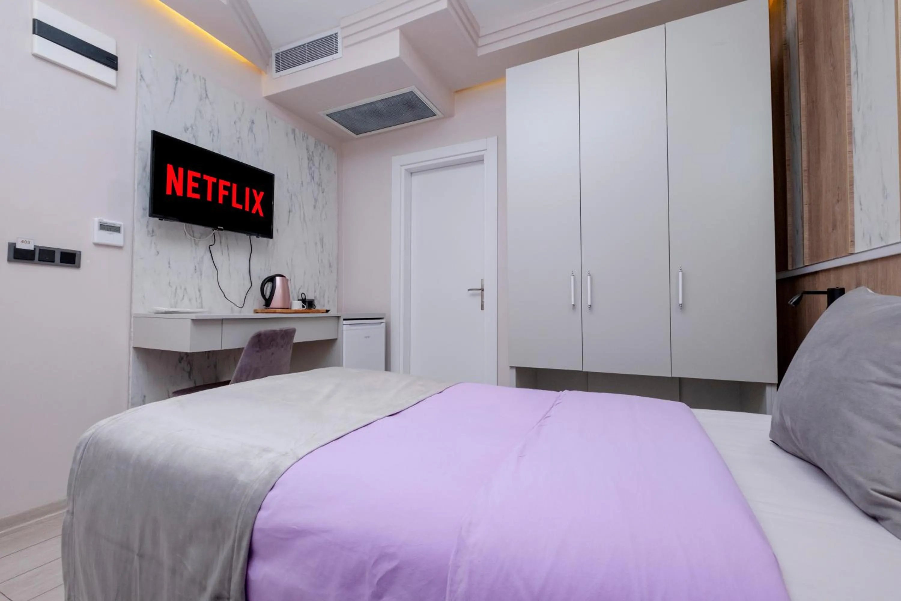 Communal lounge/ TV room, Bed in Lavender Airport Hotel