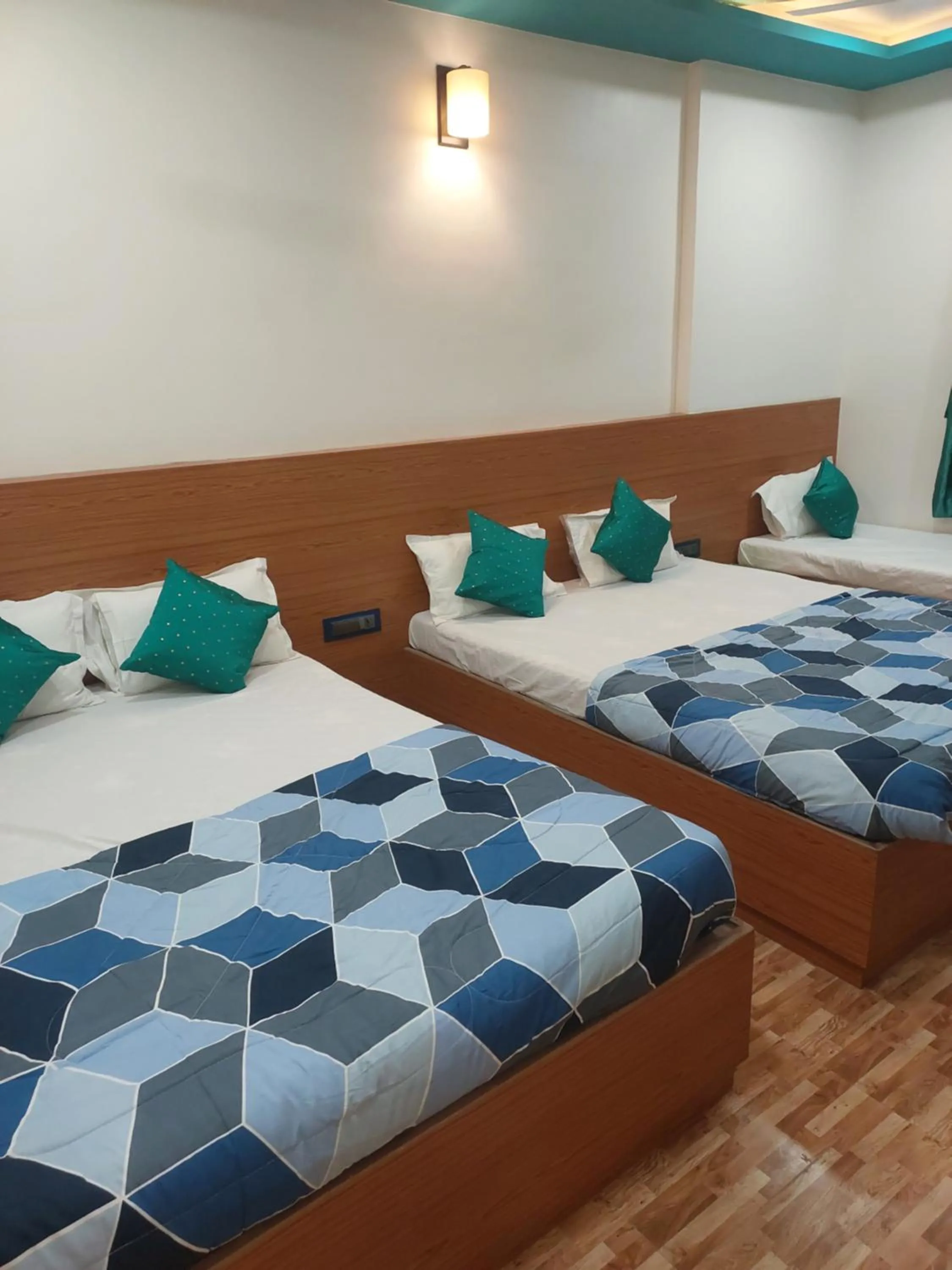 Bed in Hotel Sai Dakshina Inn & The Fern Restaurant