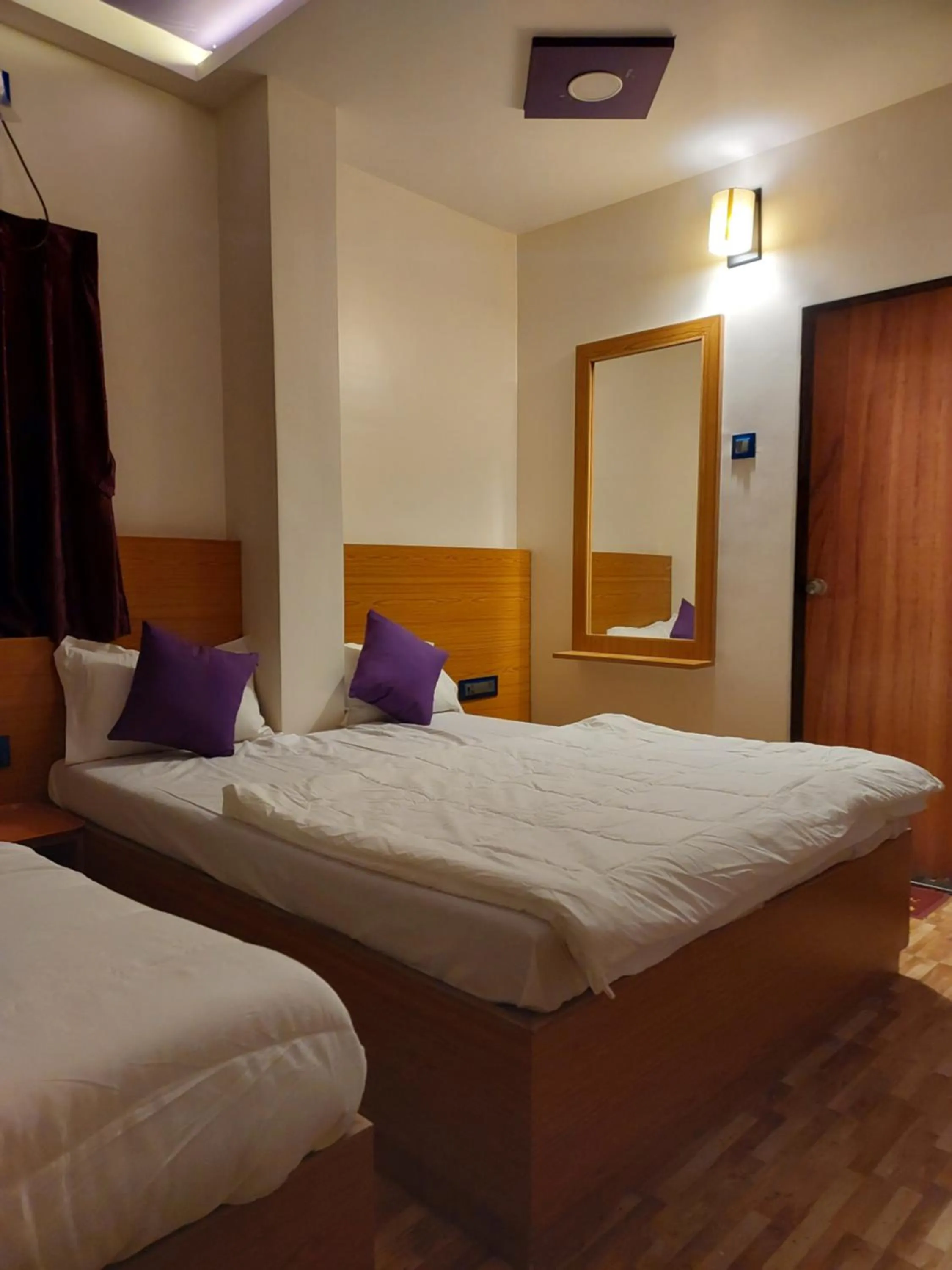 Bed in Hotel Sai Dakshina Inn & The Fern Restaurant