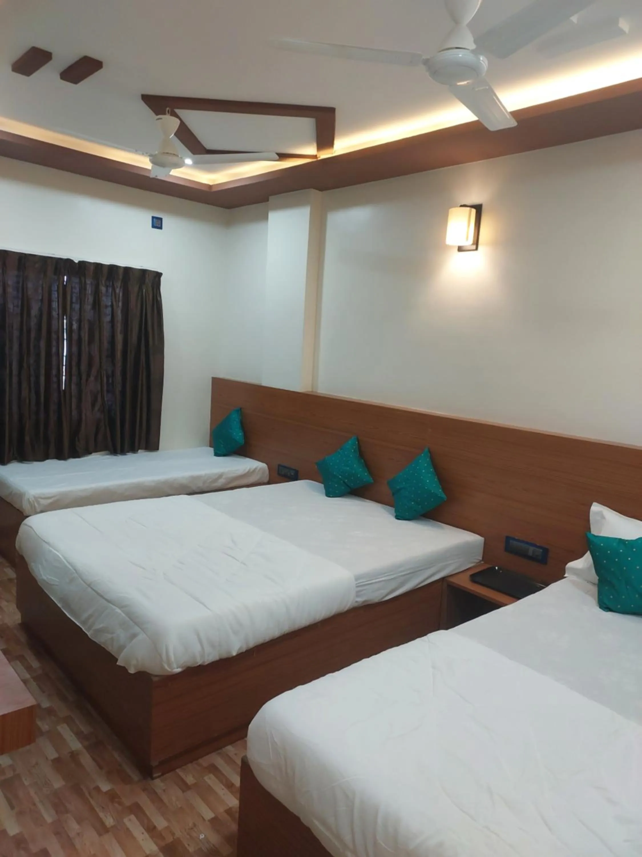 Bed in Hotel Sai Dakshina Inn & The Fern Restaurant