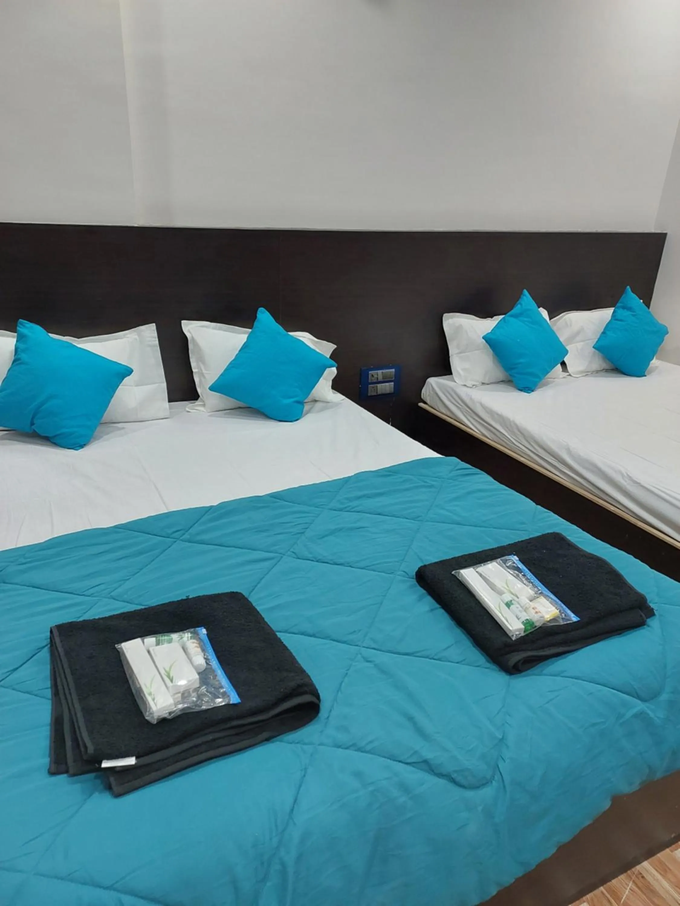 Bed in Hotel Sai Dakshina Inn & The Fern Restaurant