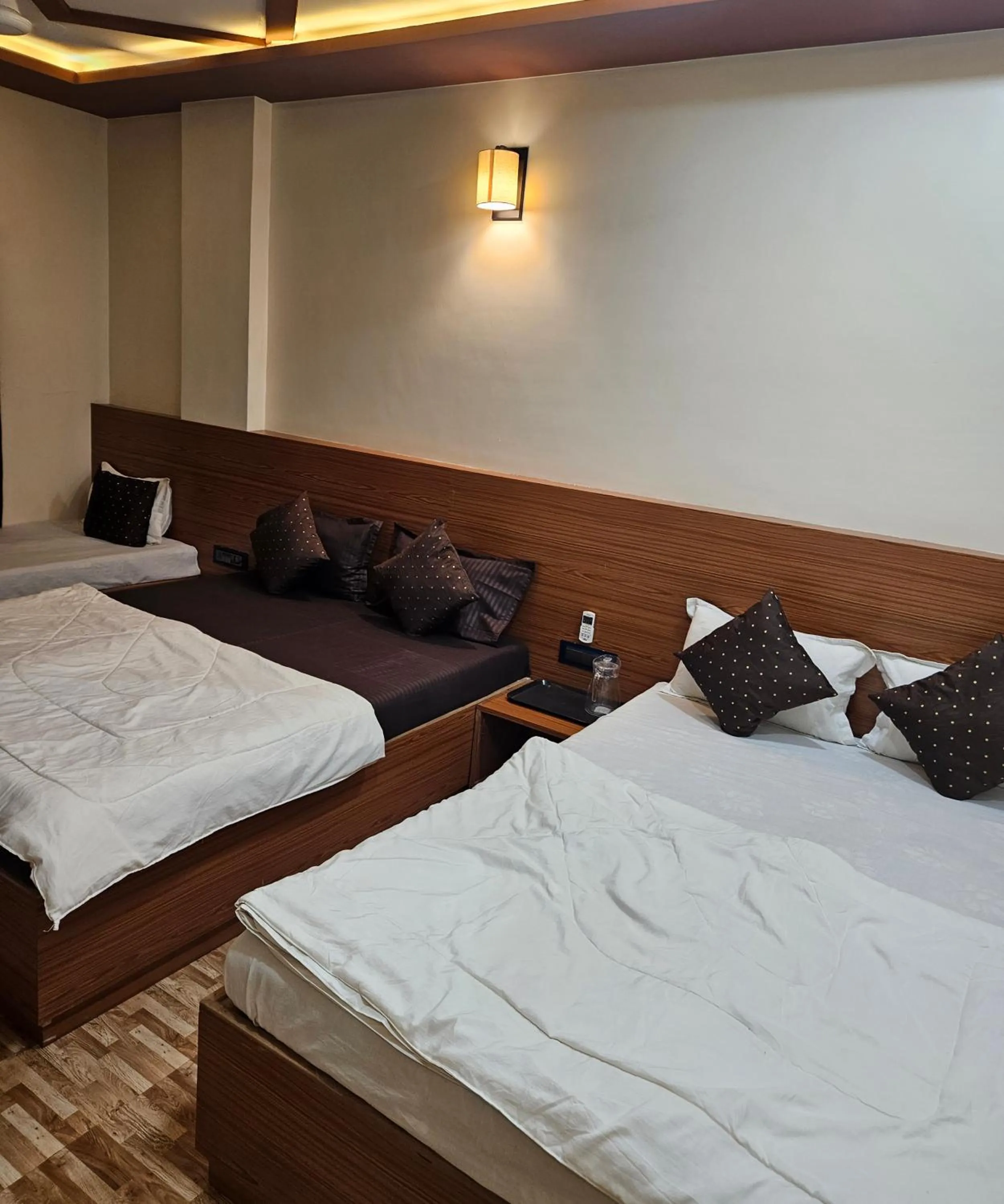 Bed in Hotel Sai Dakshina Inn & The Fern Restaurant