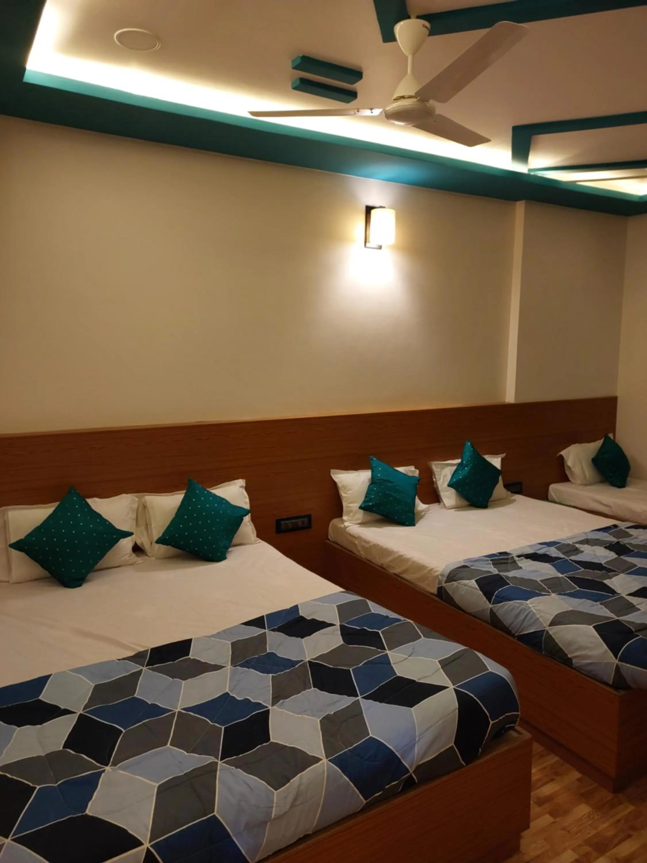 Bed in Hotel Sai Dakshina Inn & The Fern Restaurant