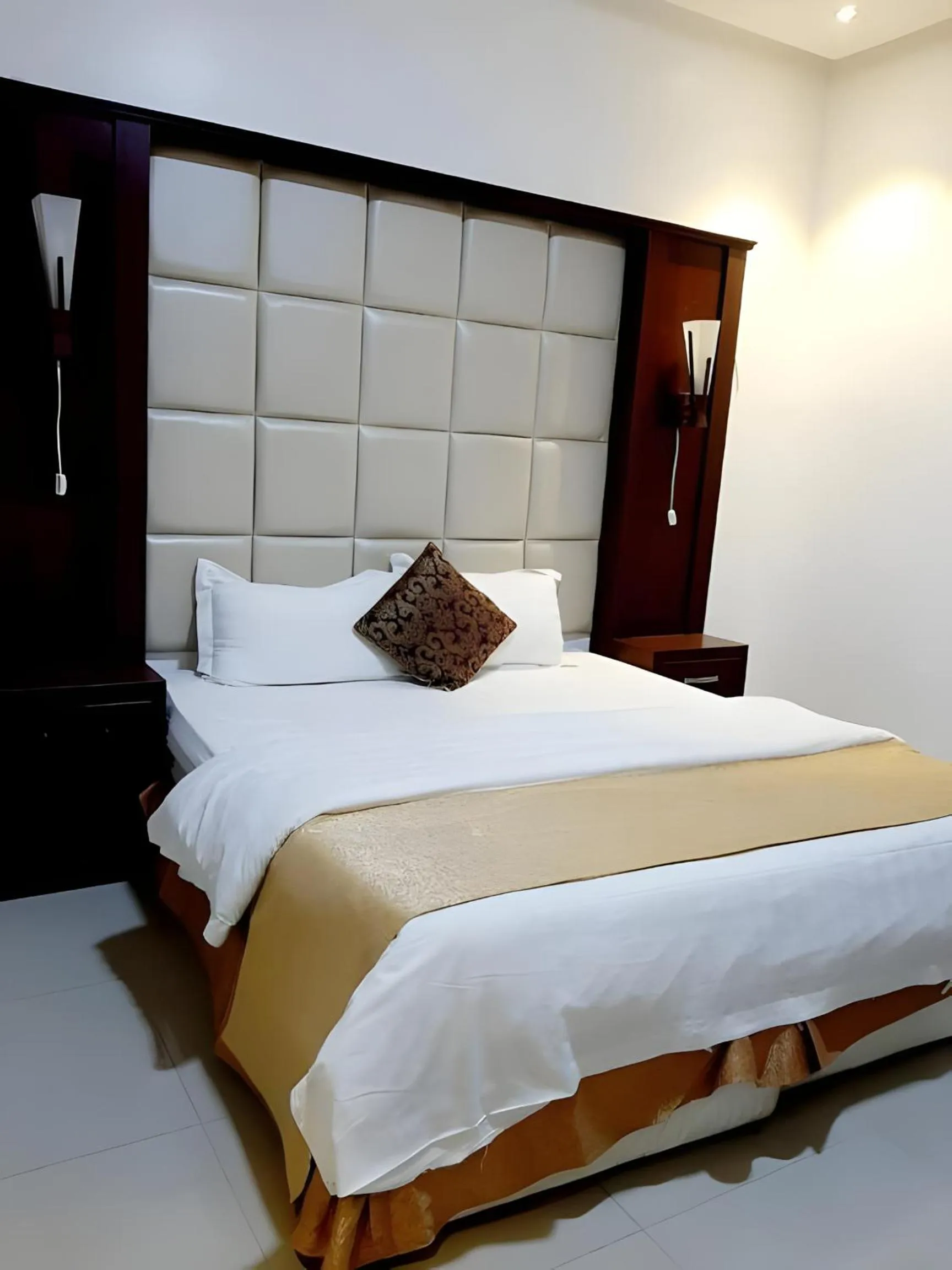 Bed in شقق أهلين ثلاثة للشقق المخدومة