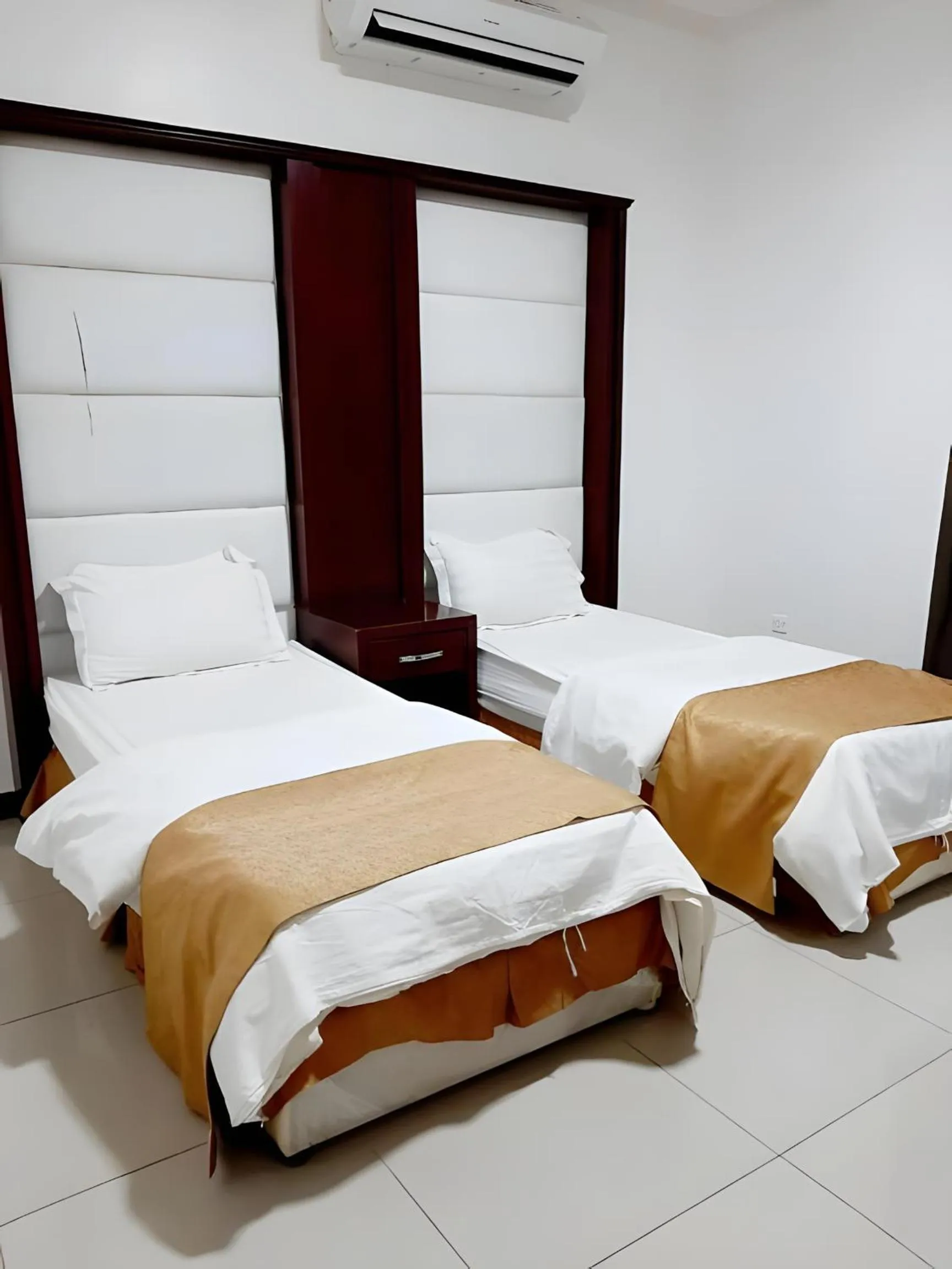 Bed in شقق أهلين ثلاثة للشقق المخدومة