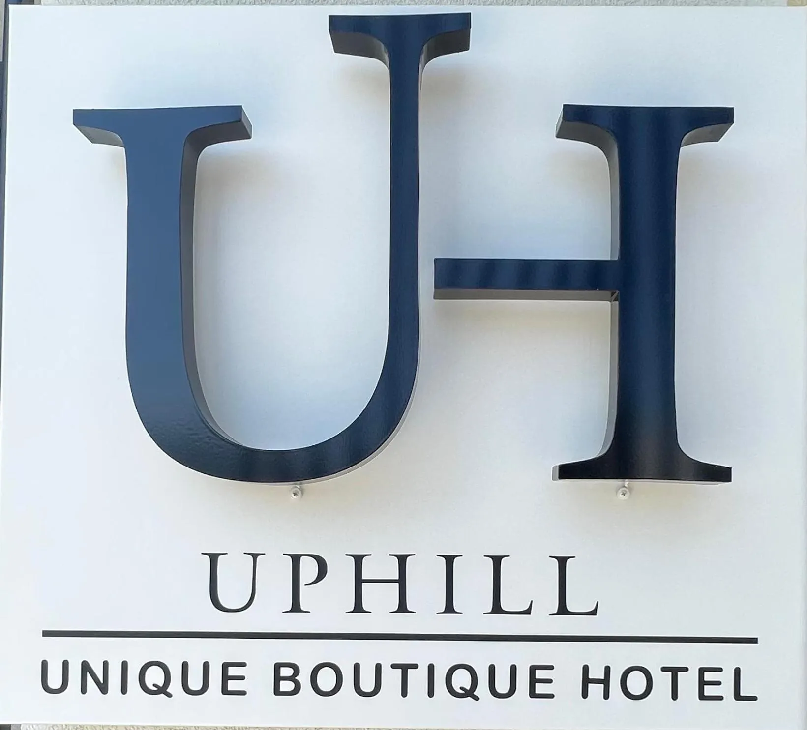 Property logo or sign in Uphill Unique Boutique Suites