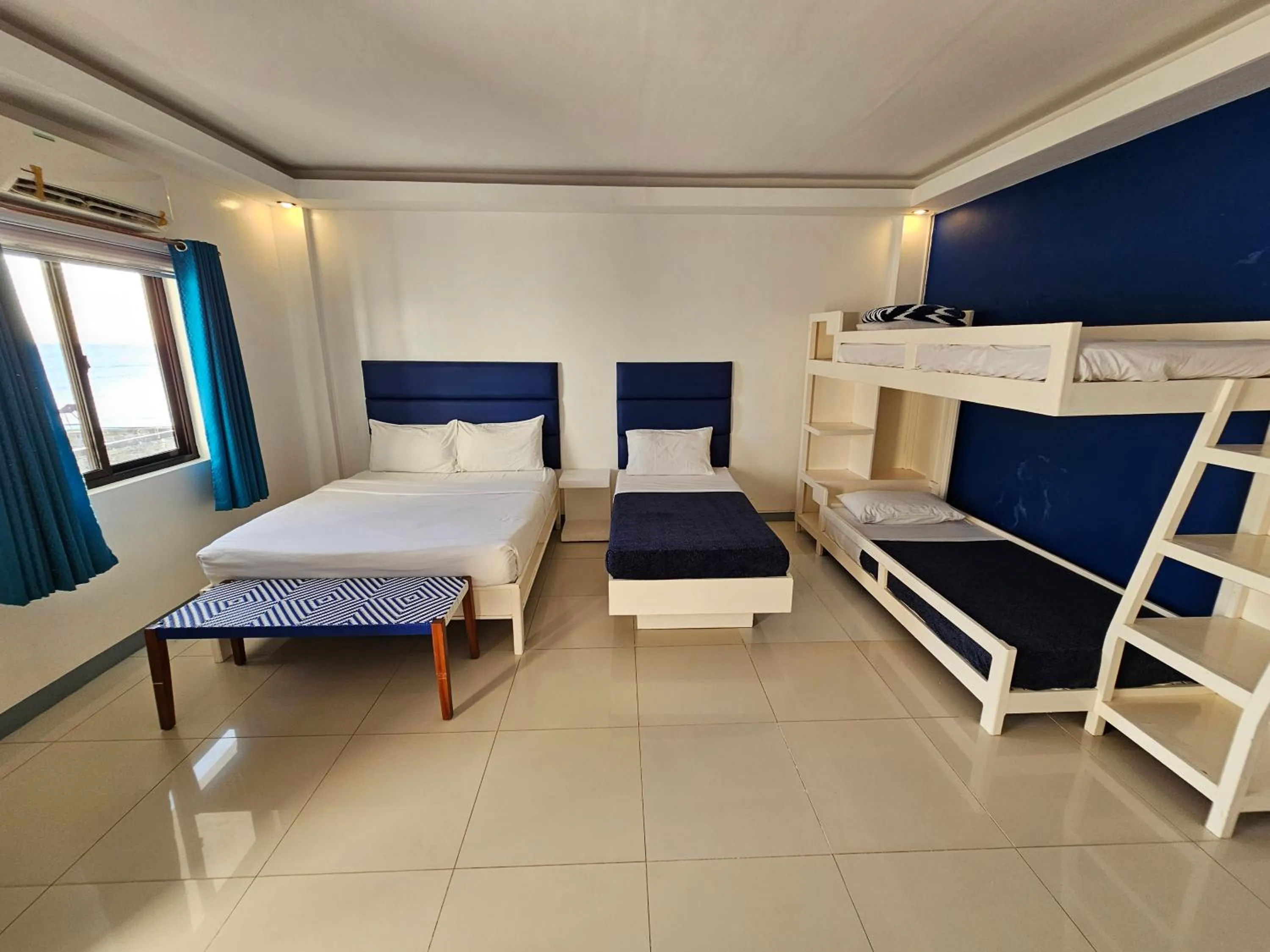 Bed in Blue Coast Beach Hotel