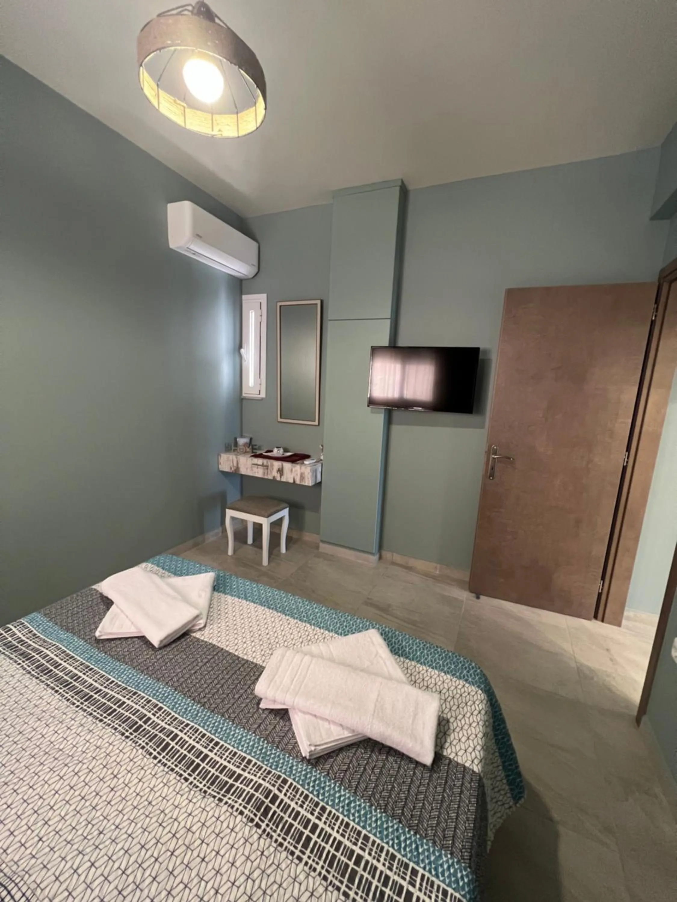 Bed in Akrotiri Luxury Suites