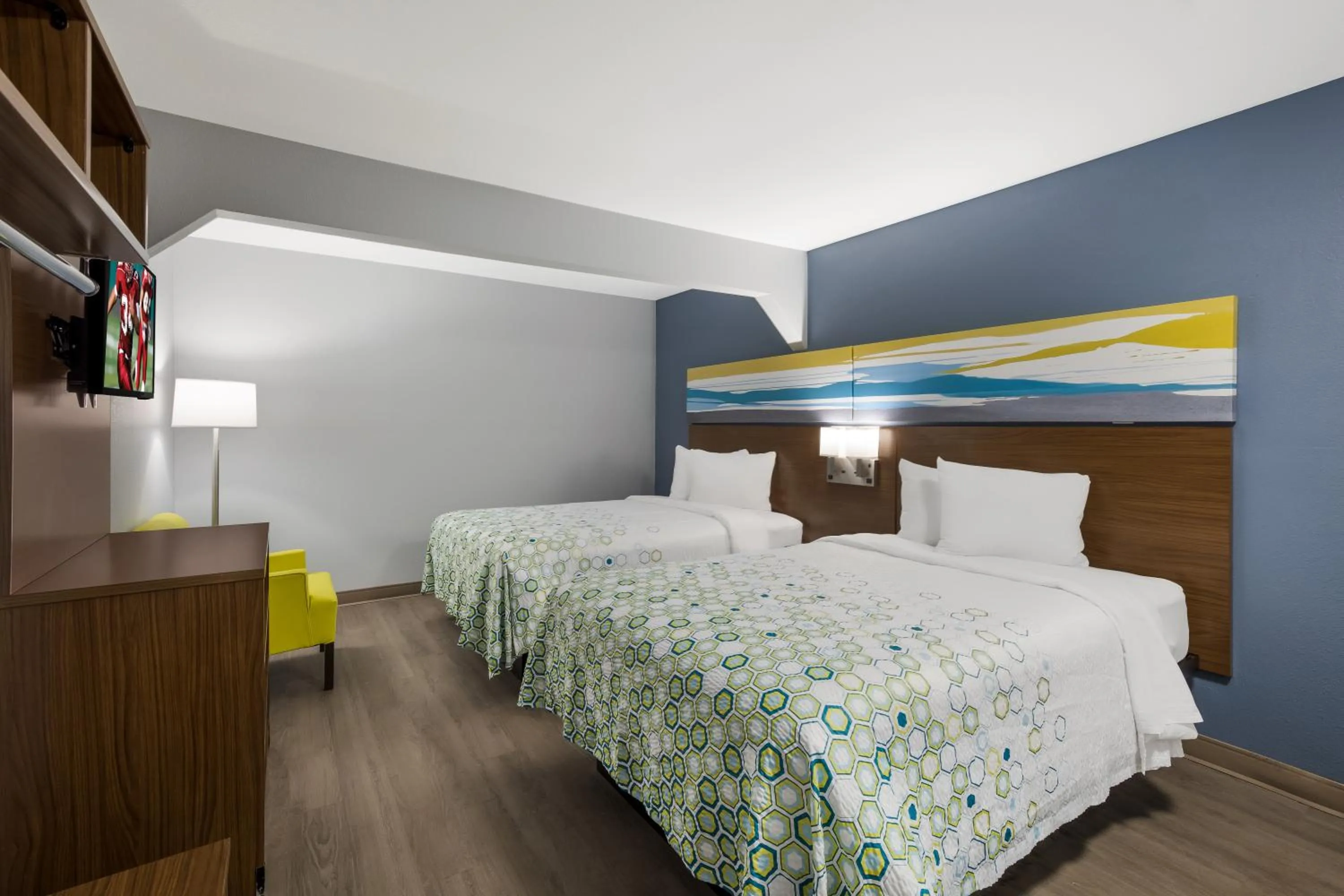 Bed in HomeTowne Studios by Red Roof Orange, TX