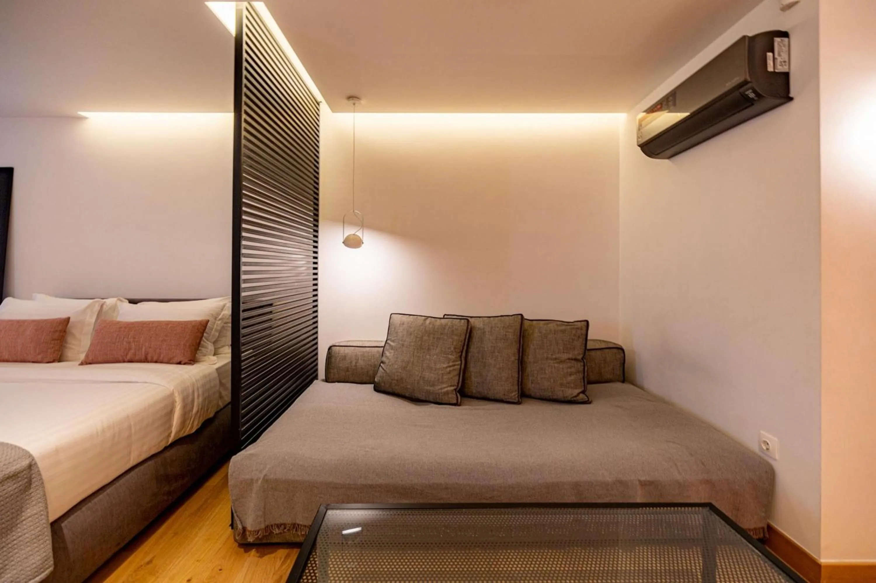 Bed in Earth Boutique Apartments next to Stavros Niarchos