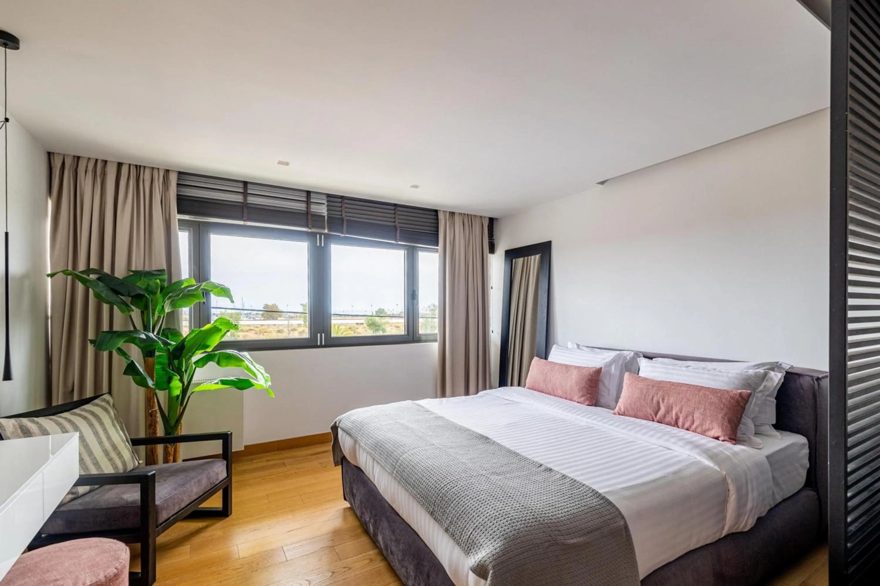 Bed in Earth Boutique Apartments next to Stavros Niarchos