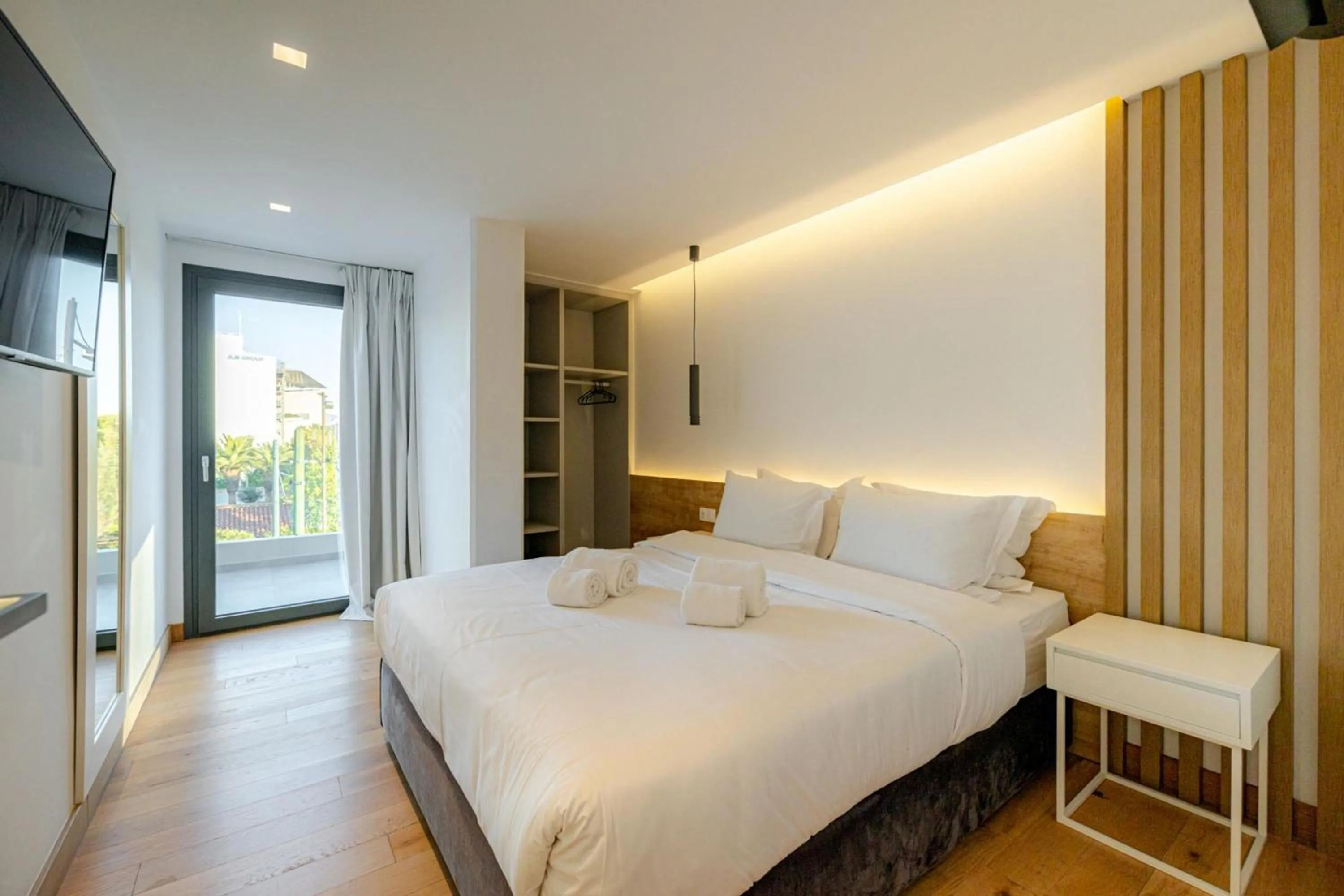 Bed in Earth Boutique Apartments next to Stavros Niarchos