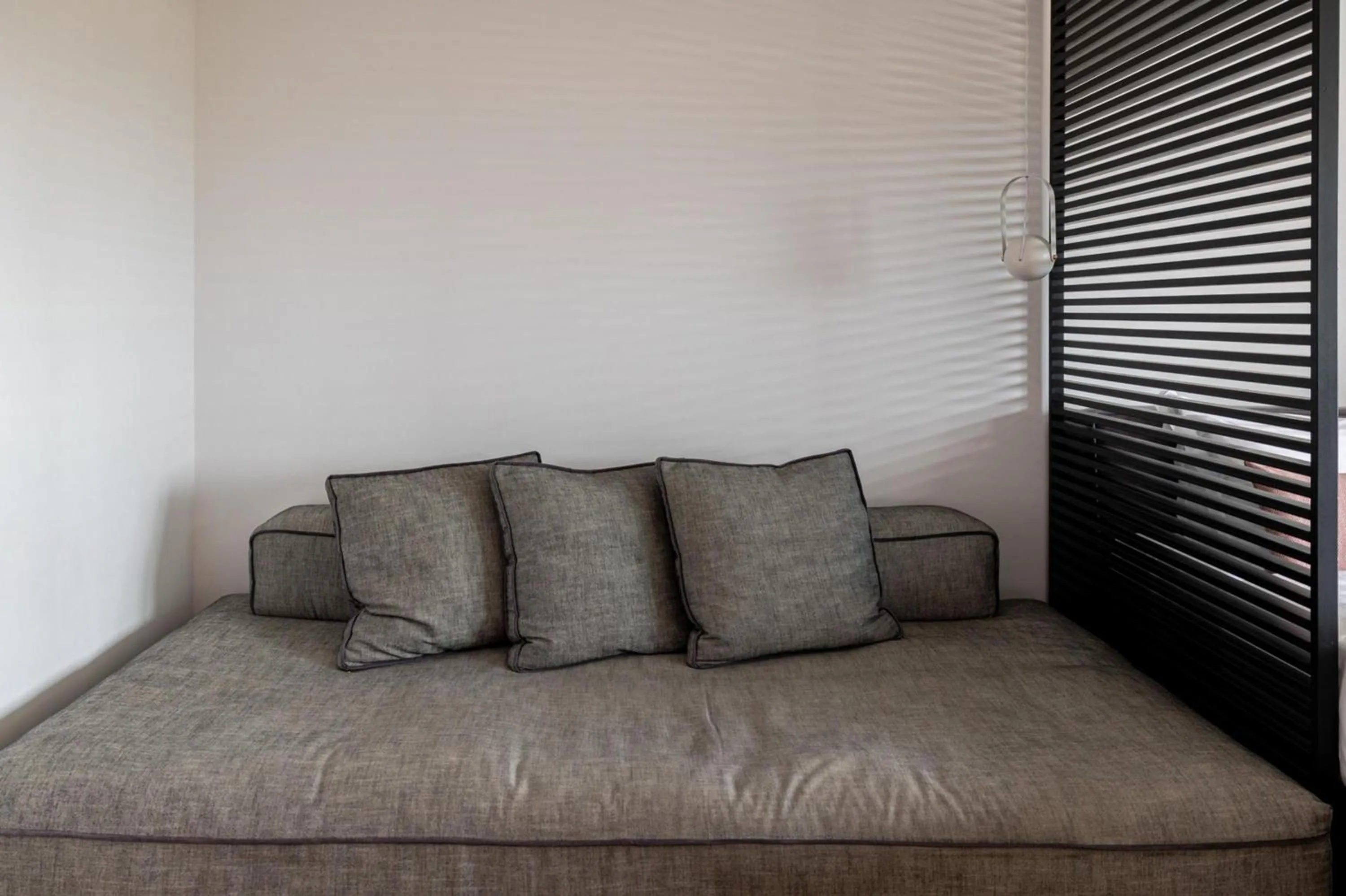 Bed in Earth Boutique Apartments next to Stavros Niarchos