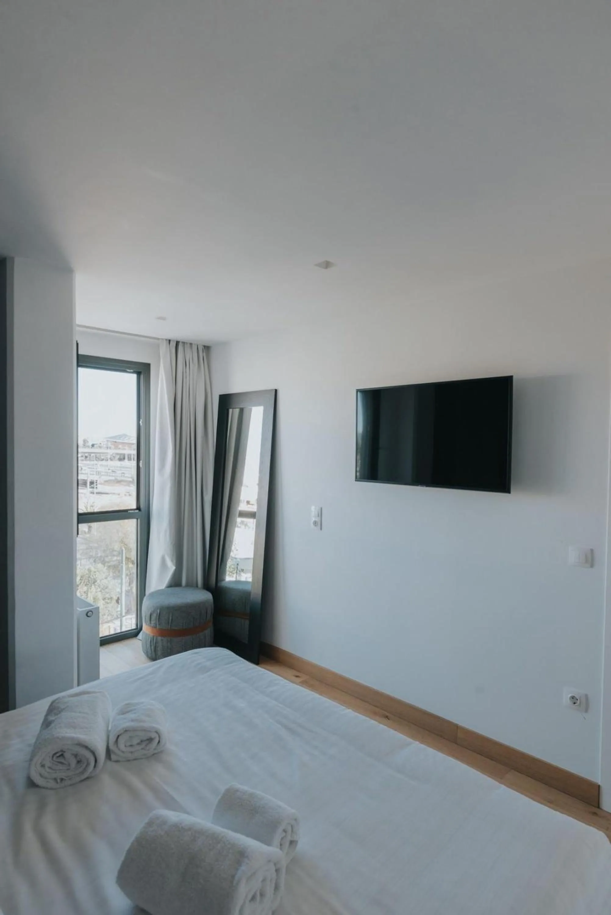 Bed in Earth Boutique Apartments next to Stavros Niarchos