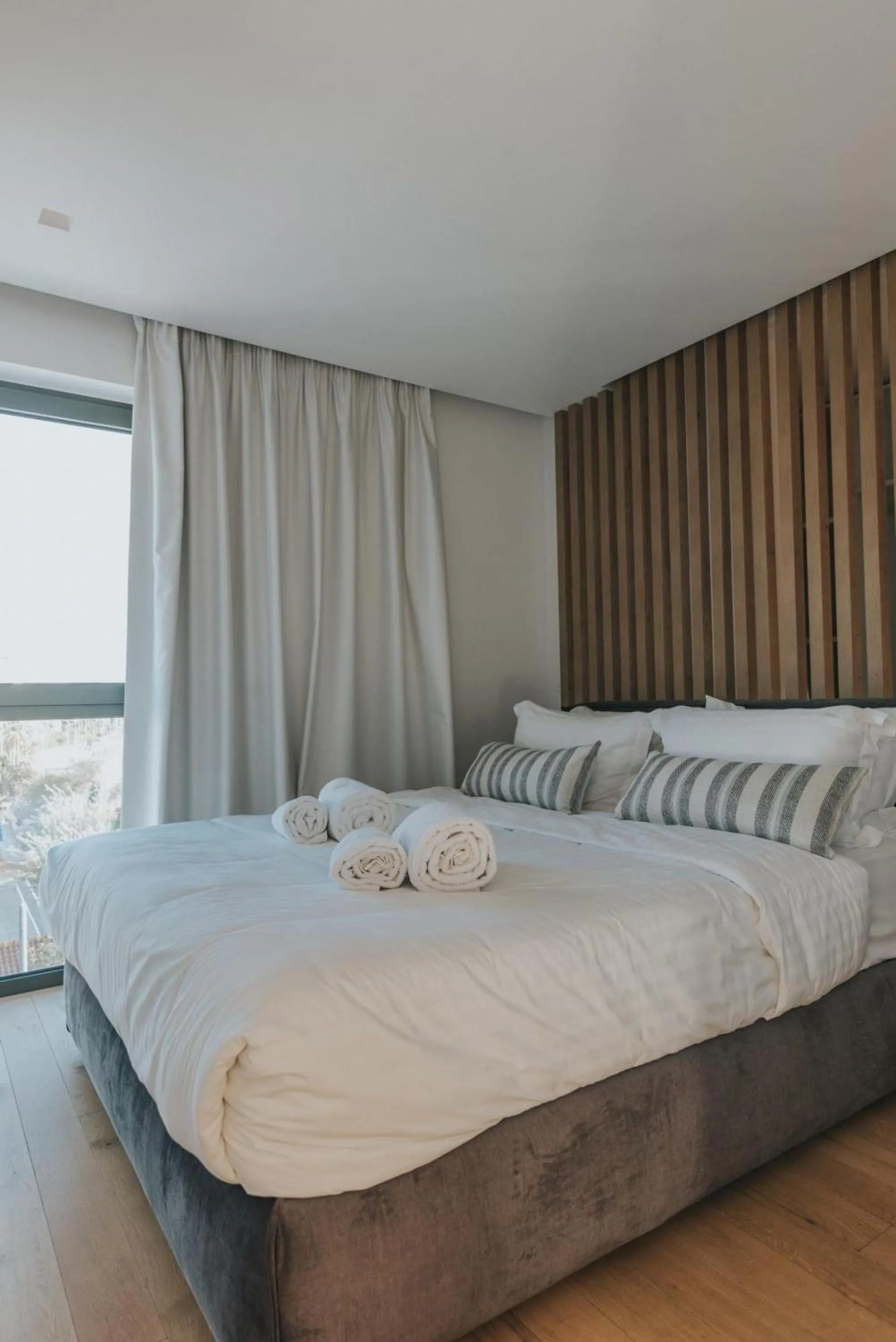 Bed in Earth Boutique Apartments next to Stavros Niarchos
