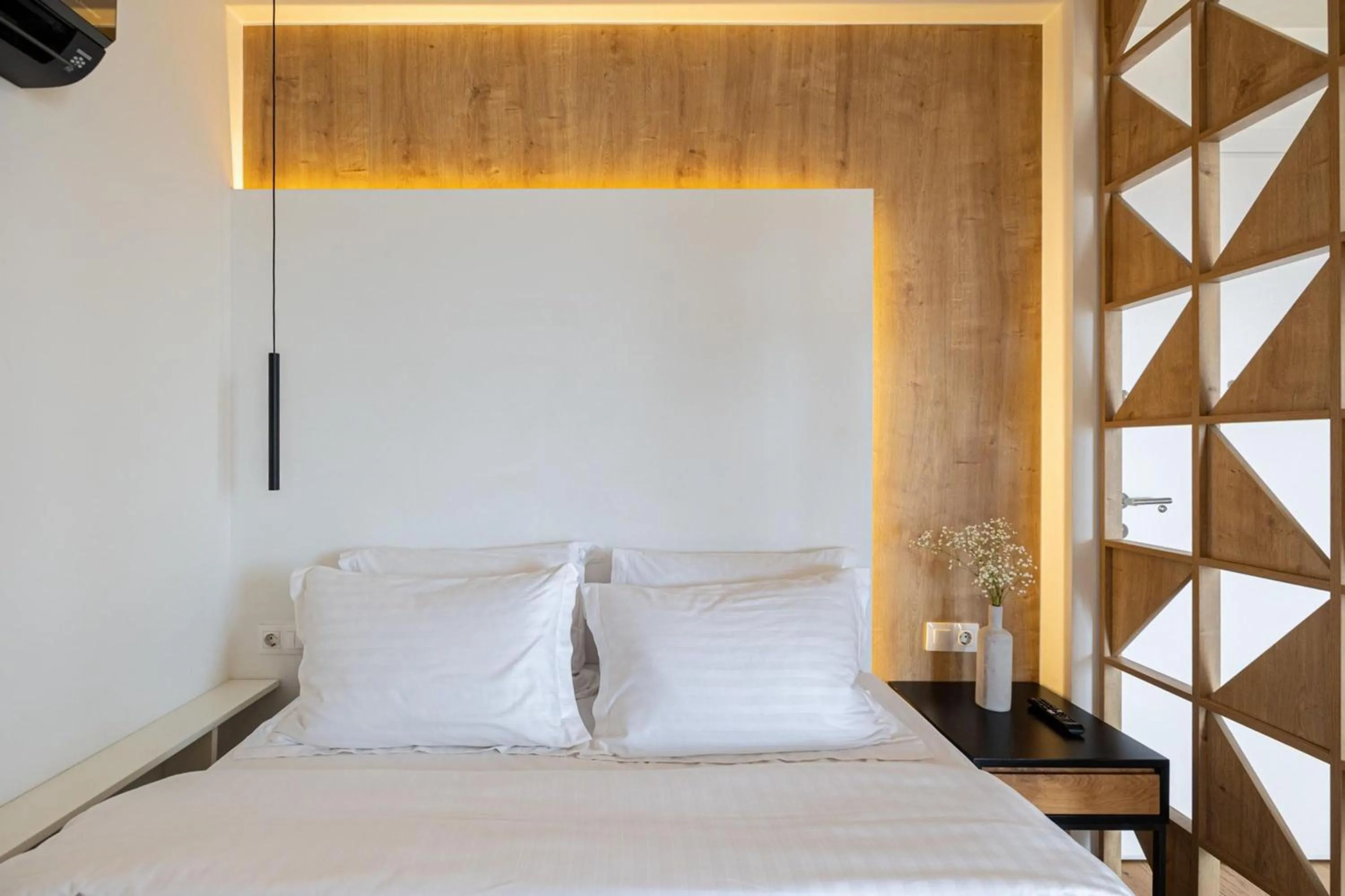 Bed in Earth Boutique Apartments next to Stavros Niarchos