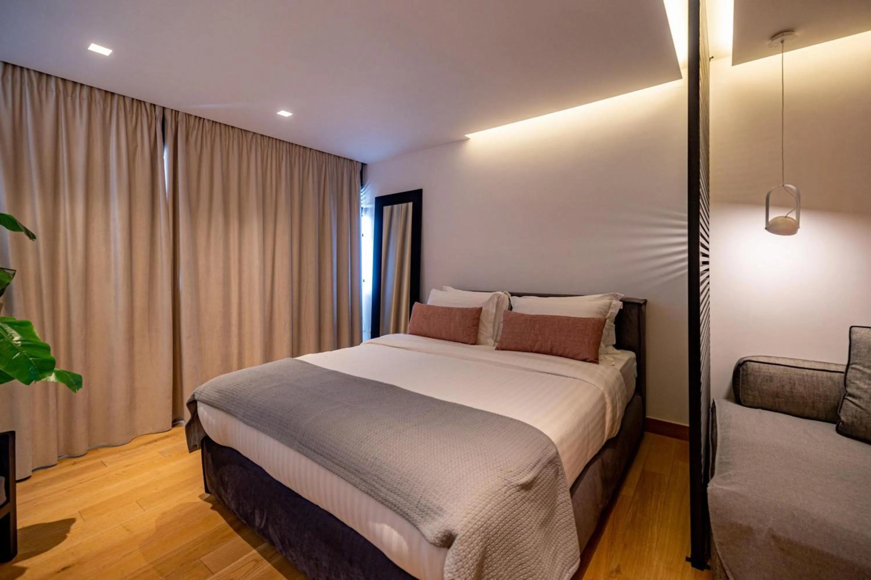 Bed in Earth Boutique Apartments next to Stavros Niarchos