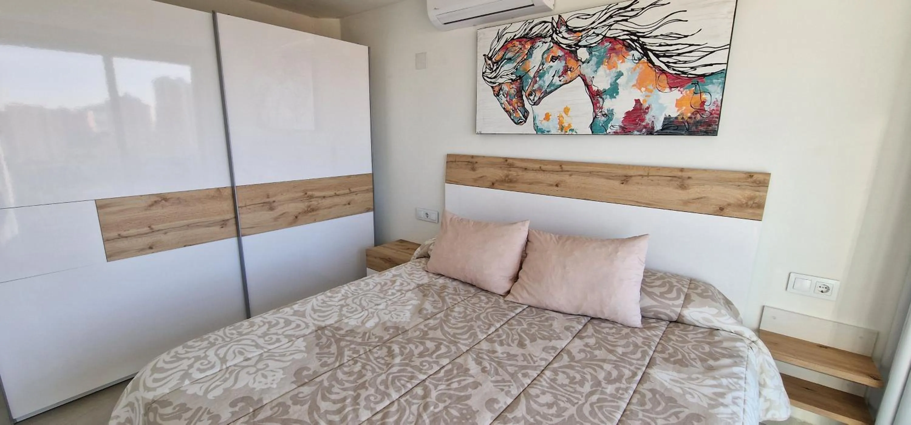 Bed in APARTAMENTOS OASIS DE LA CALA