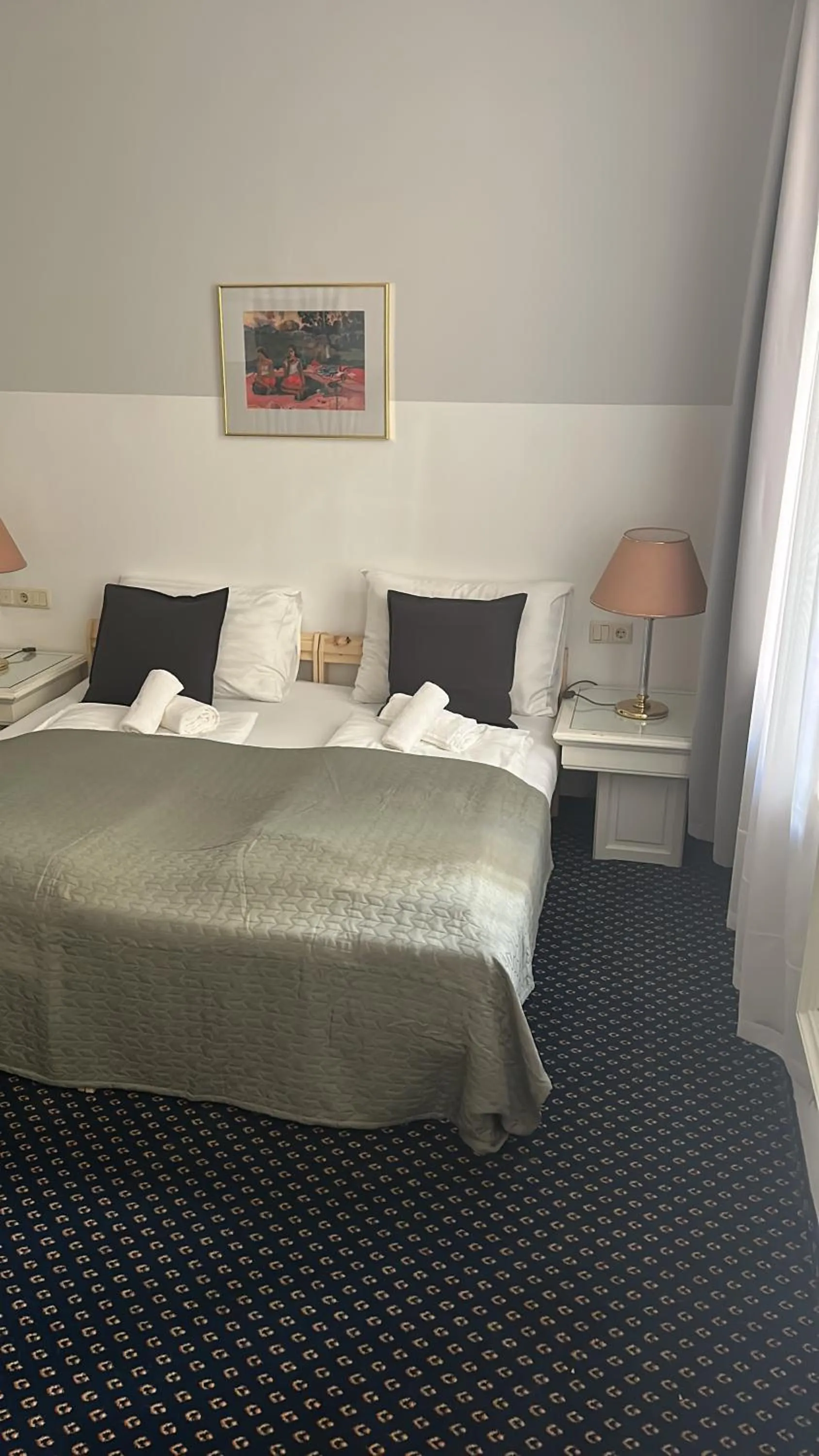 Bed in Self-Check-In Hotel Adlon