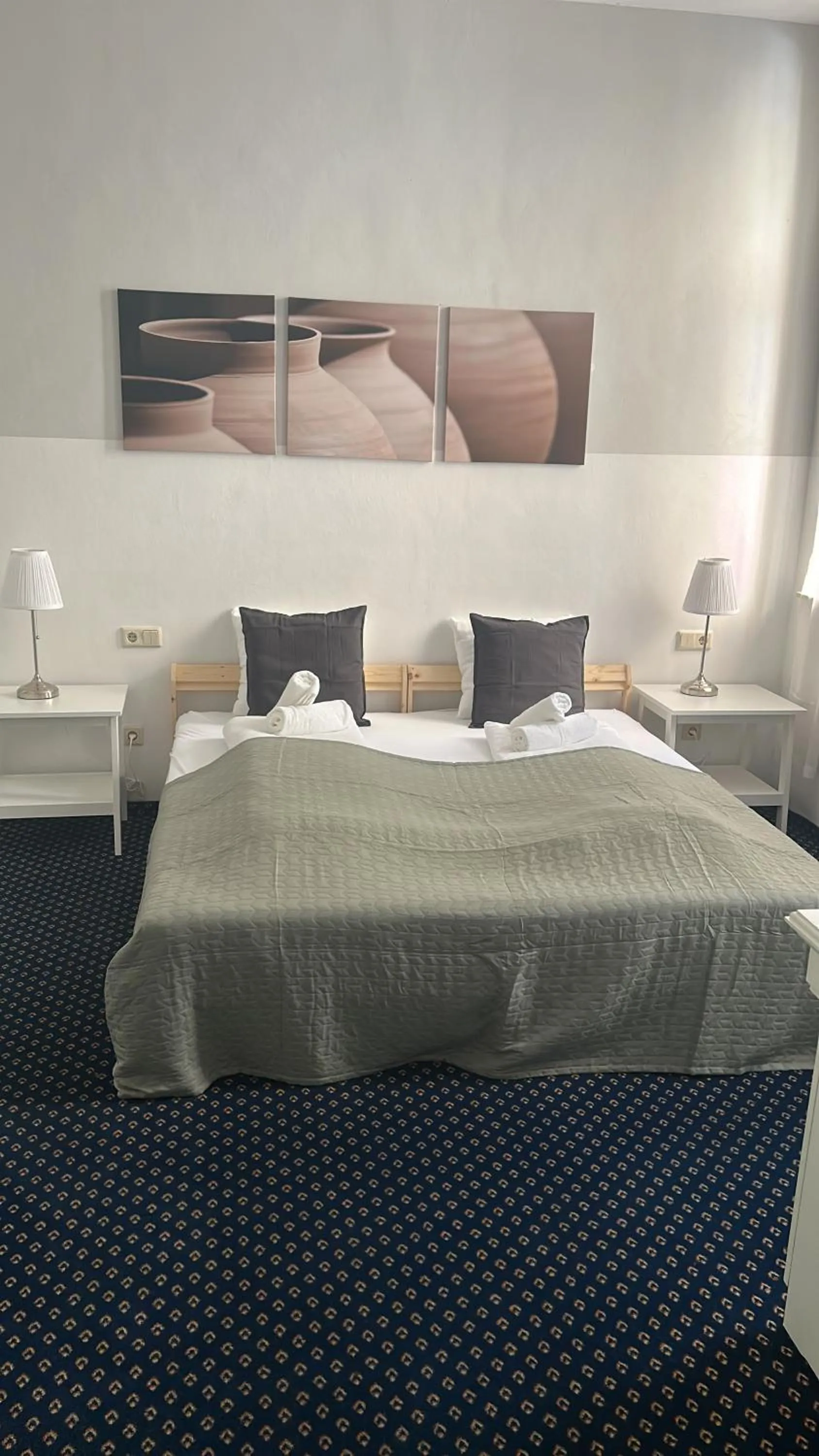 Bed in Self-Check-In Hotel Adlon