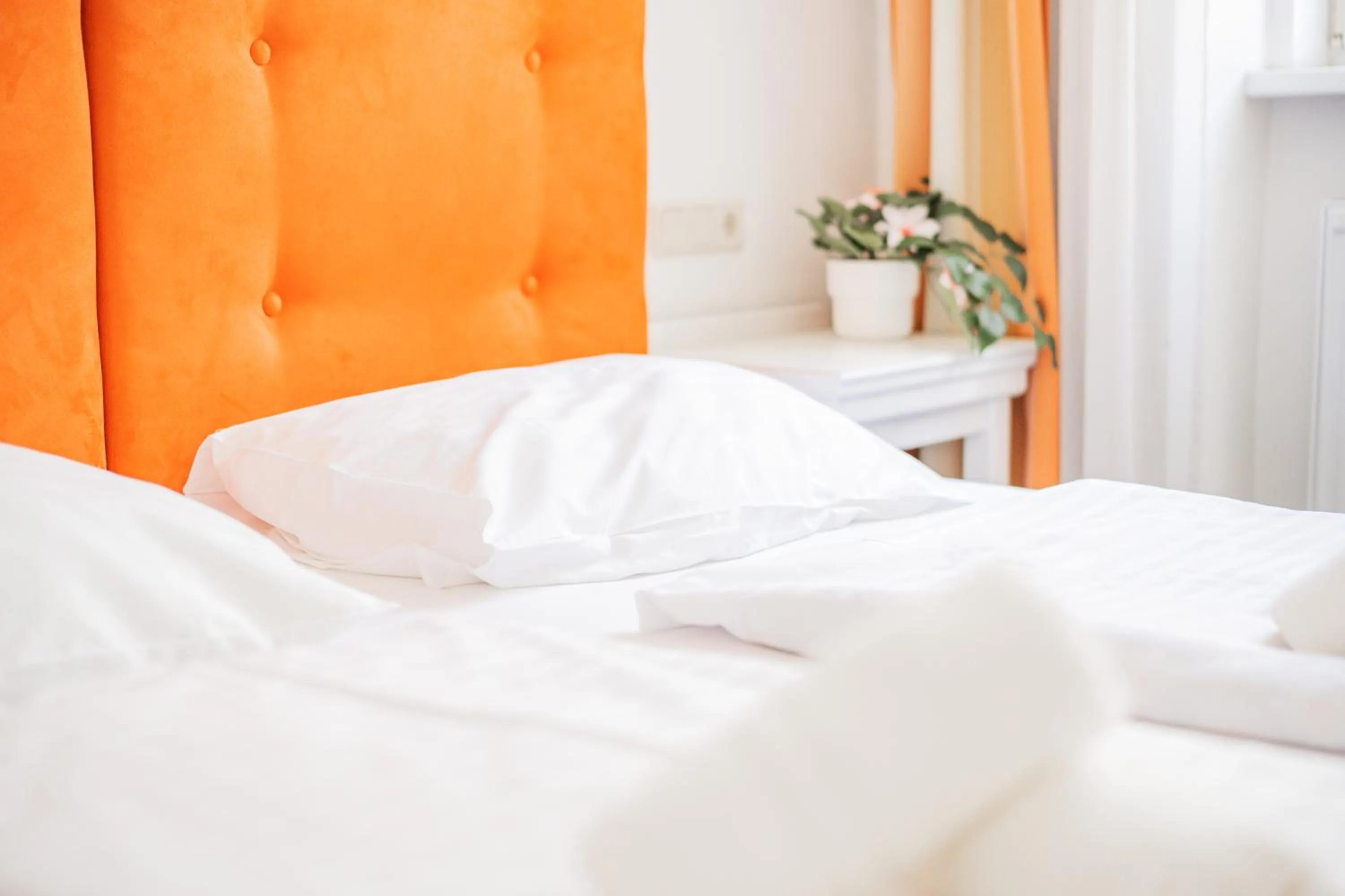 Bed in Self-Check-In Hotel Adlon