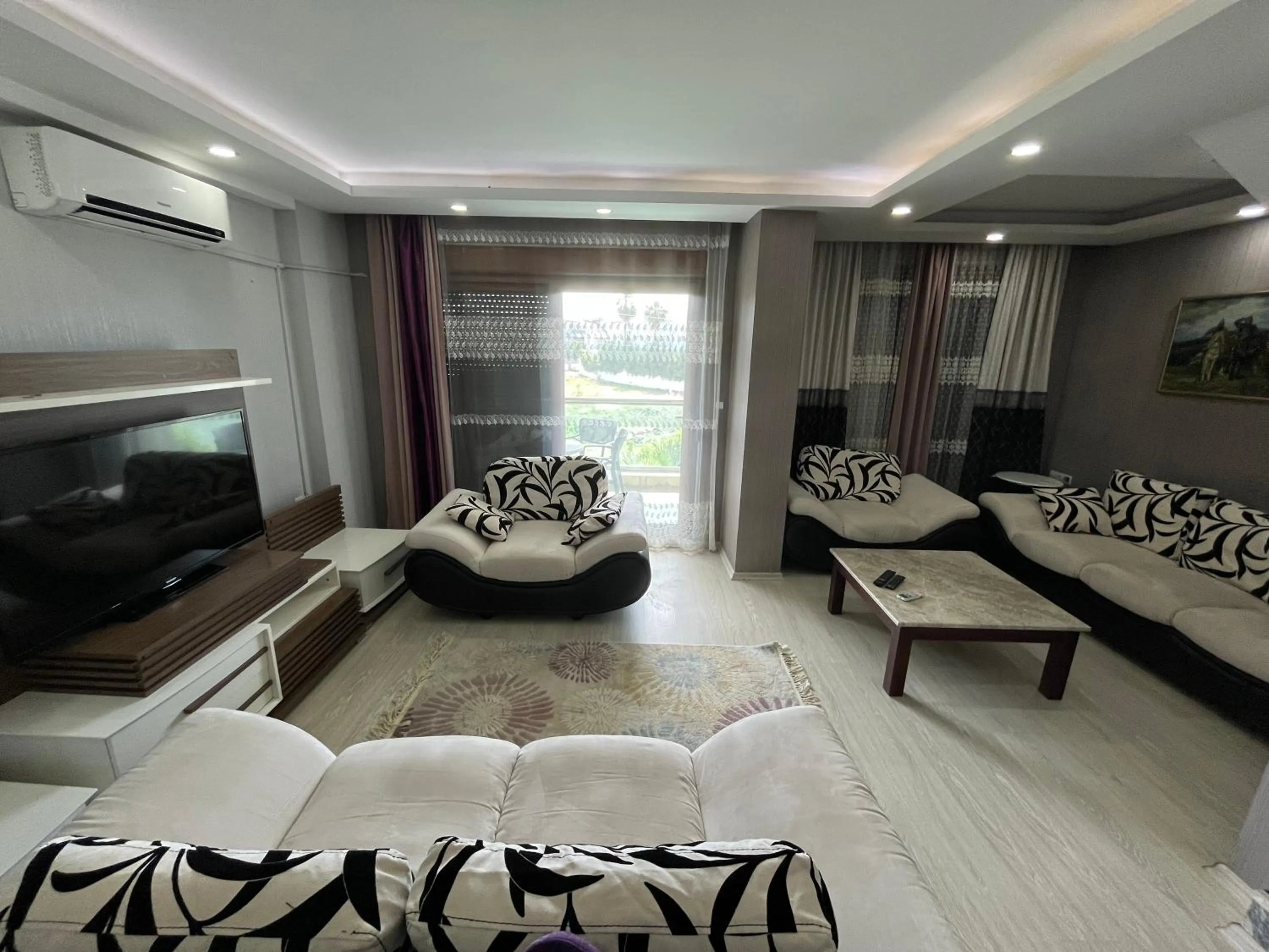 Communal lounge/ TV room in Gardenya Lara Suit Hotel