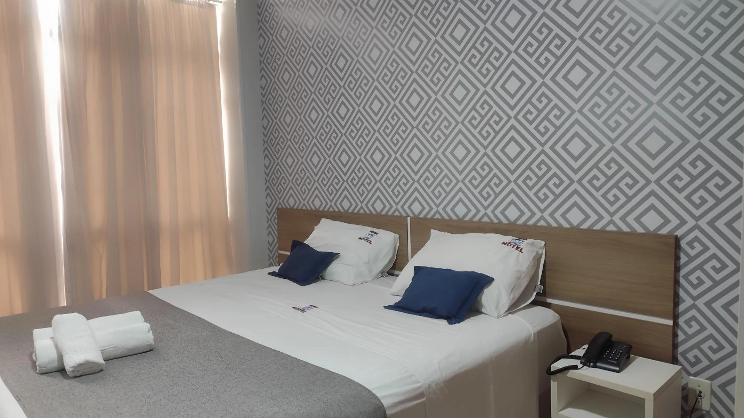 Bed in Assay Plaza Hotel