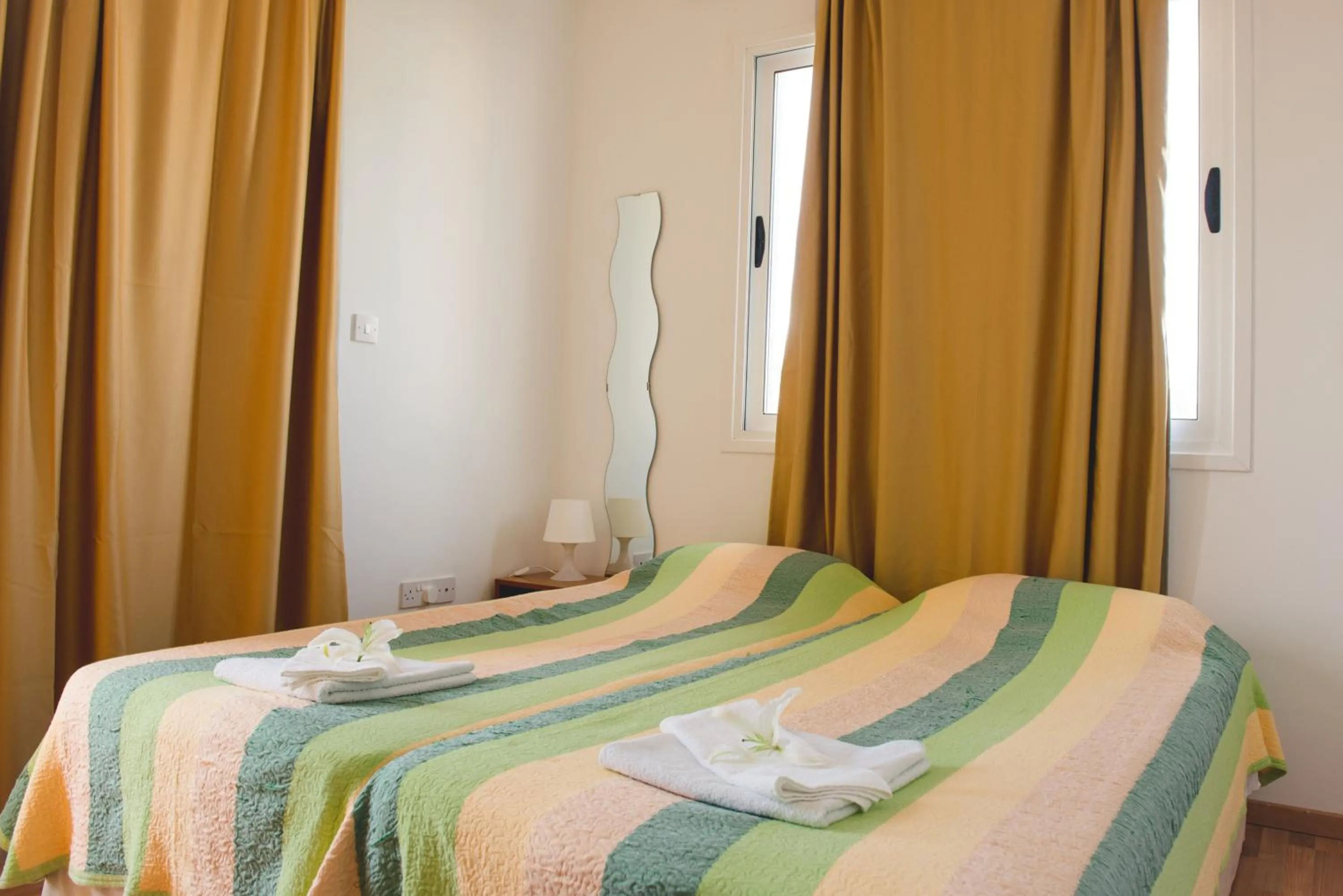 Bed in Valentinos Apartments