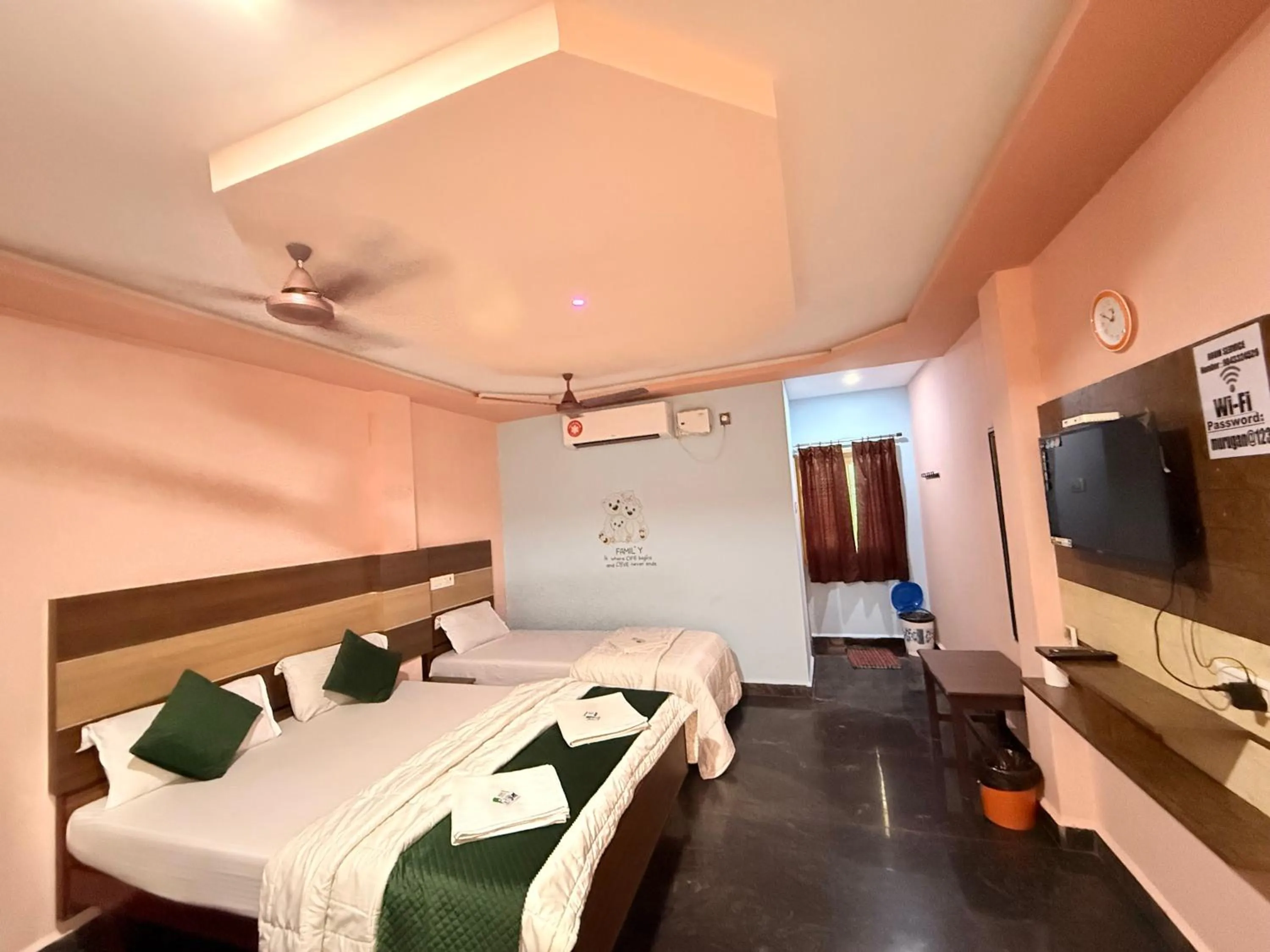 Communal lounge/ TV room, Bed in Sri Murugan Beach Paradise Hotel