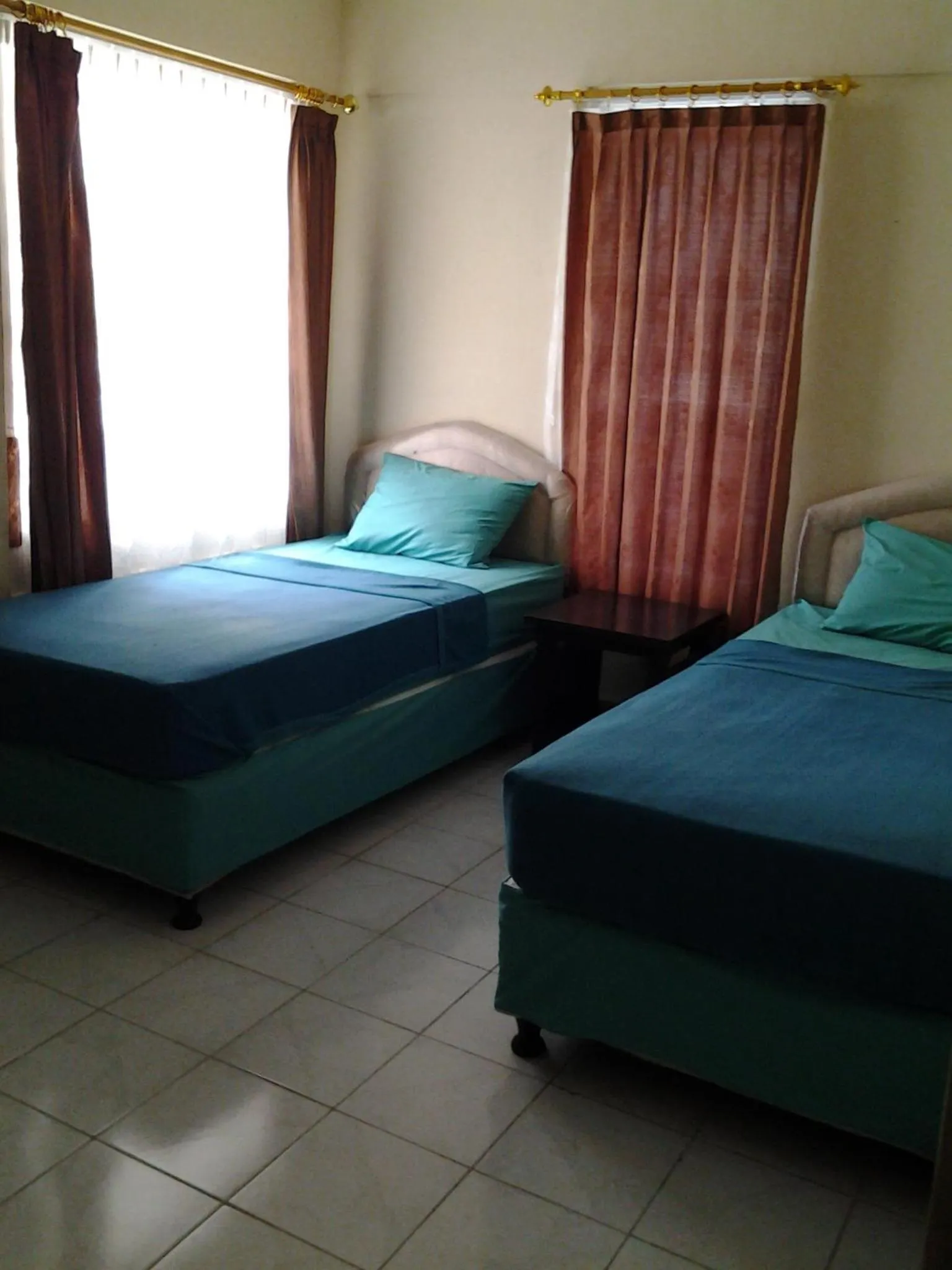 Bed in Mahendra Beach Inn