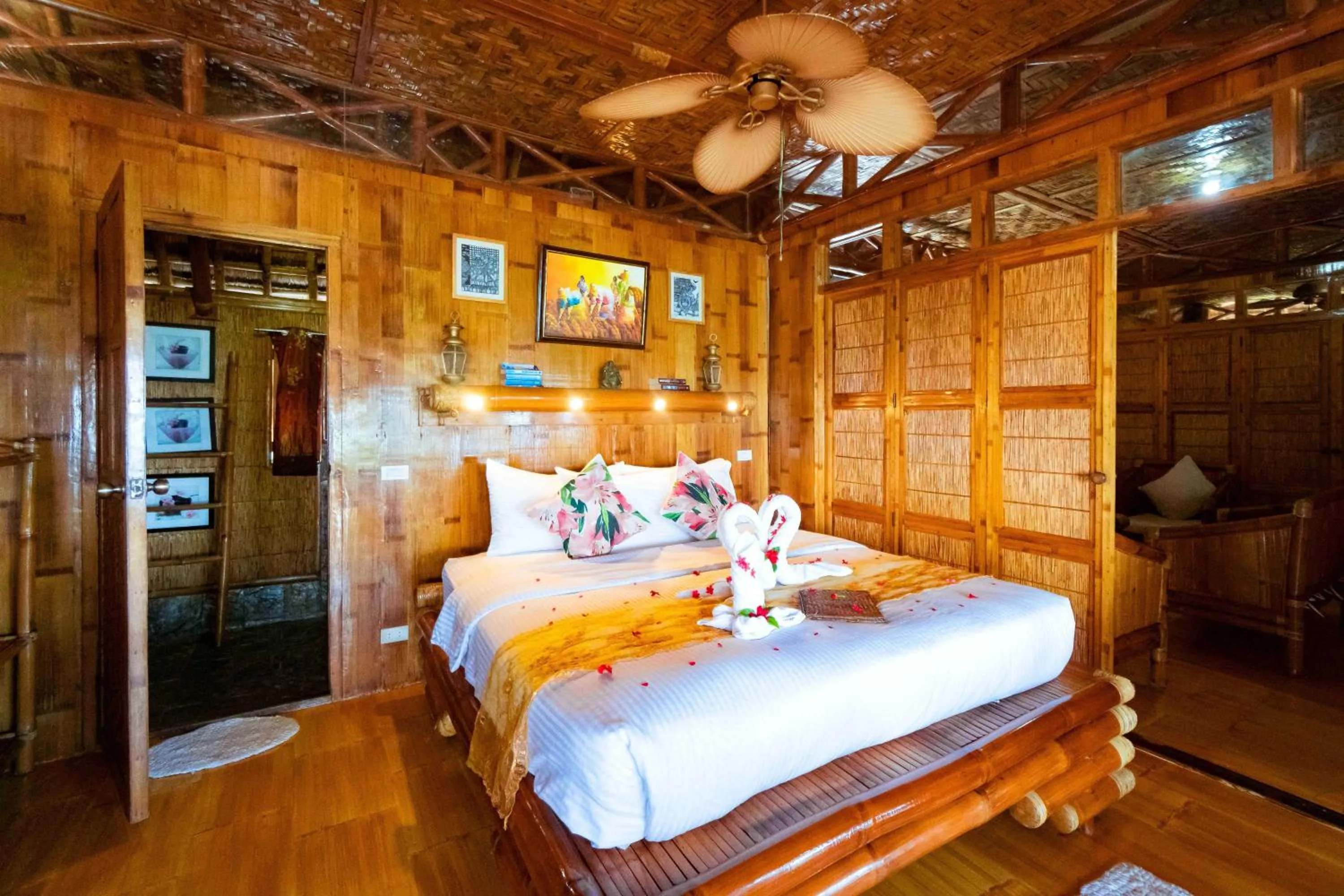 Bed in The Coral Blue Oriental Beach Villas and Suites